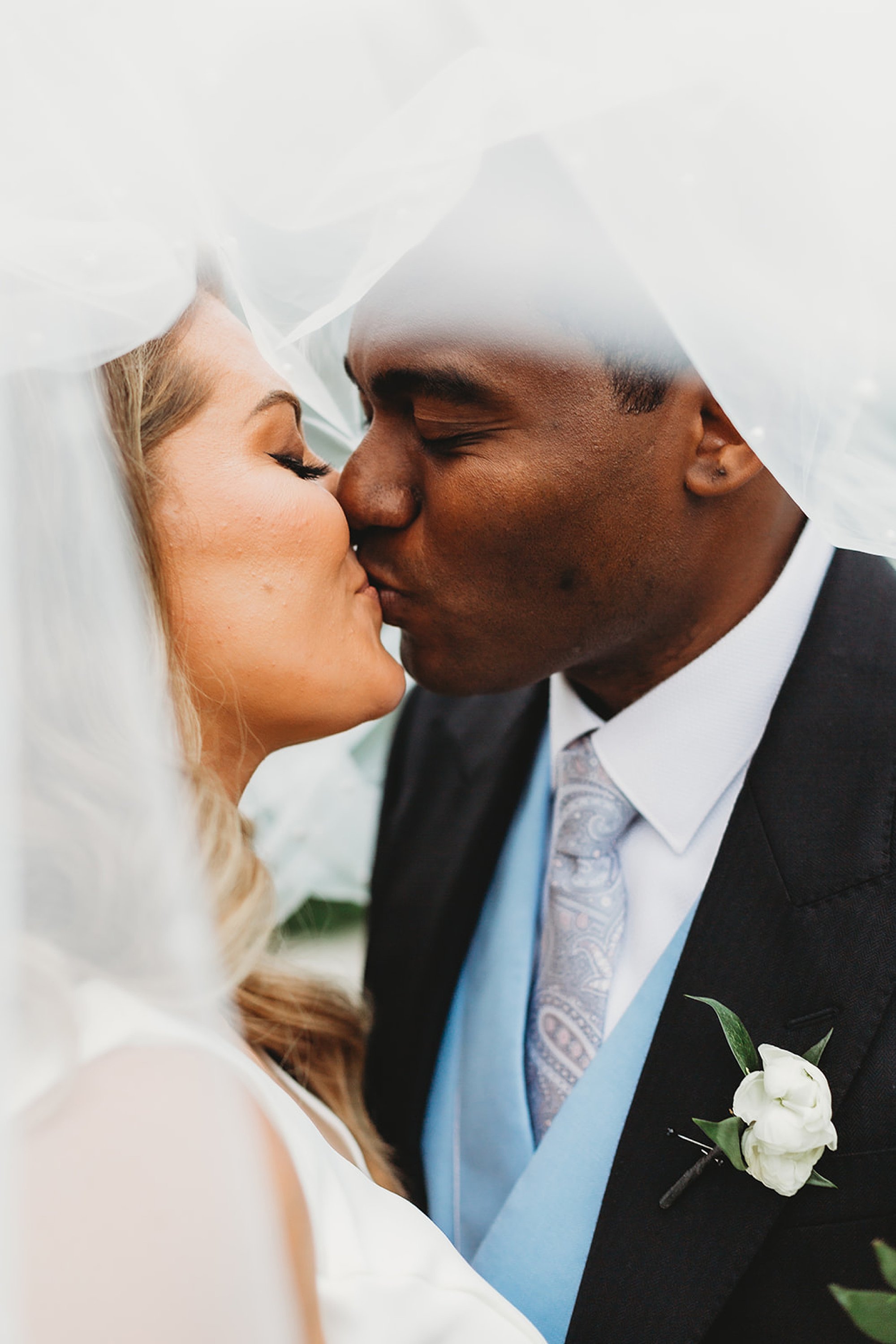 newlyweds kiss under bride's veil