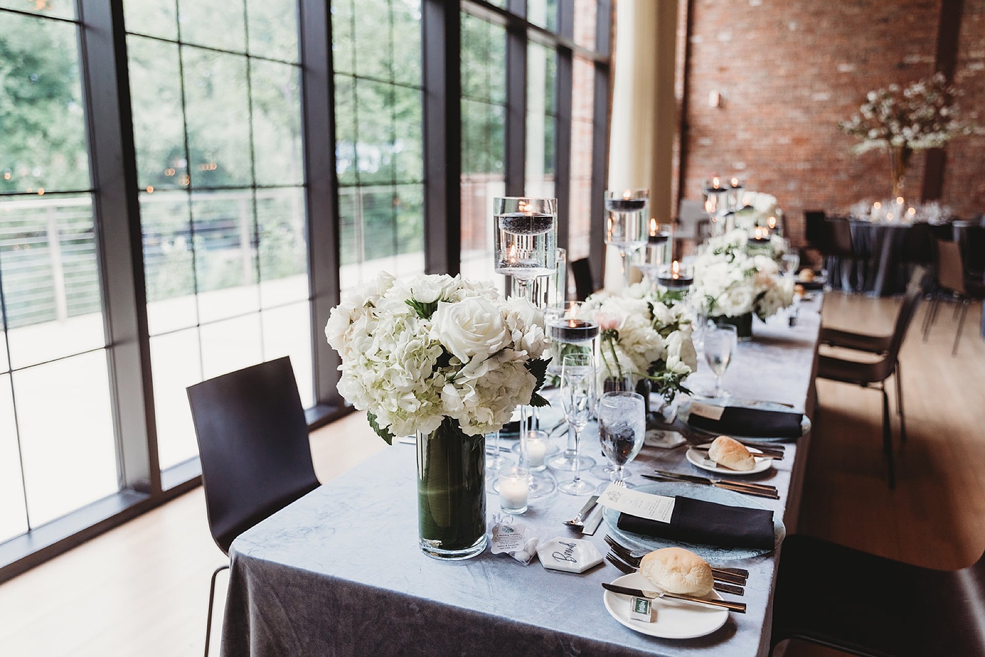family style table with white flower centerpieces at the Roadhouse