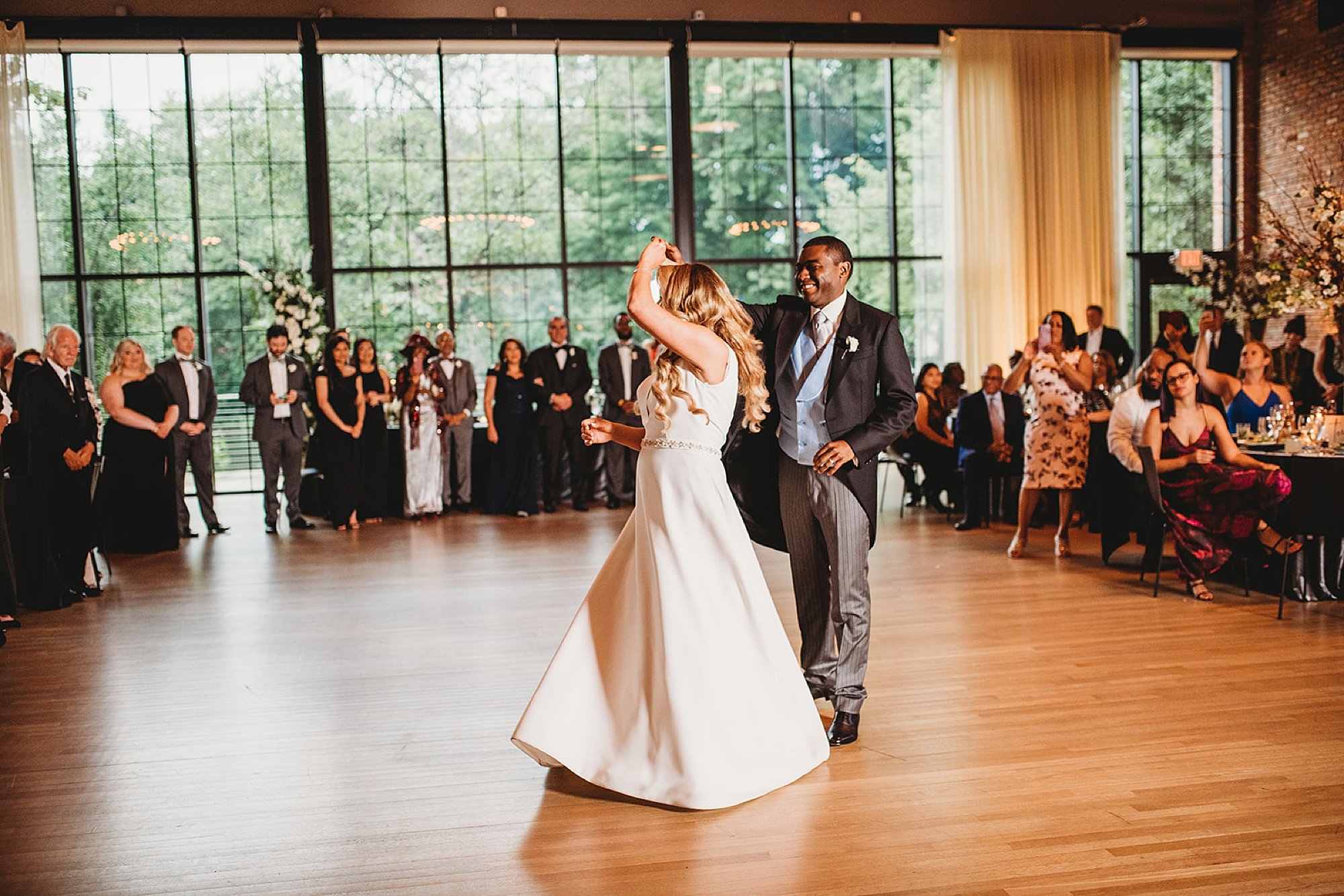 groom twirls bride during first dance at Beacon NY wedding reception