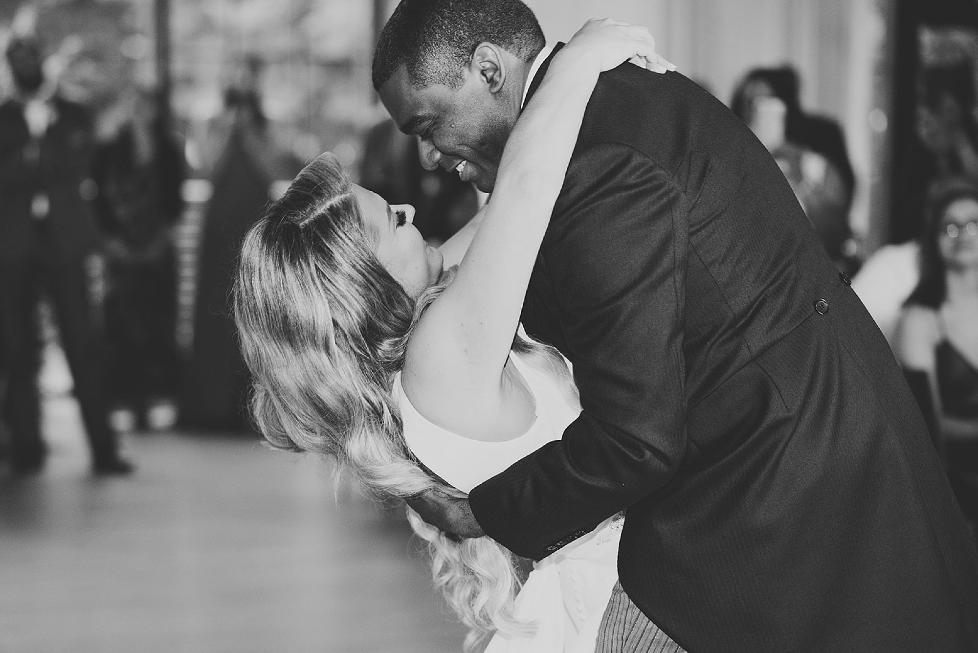 groom hugs bride dipping her at first dance at Beacon NY wedding reception
