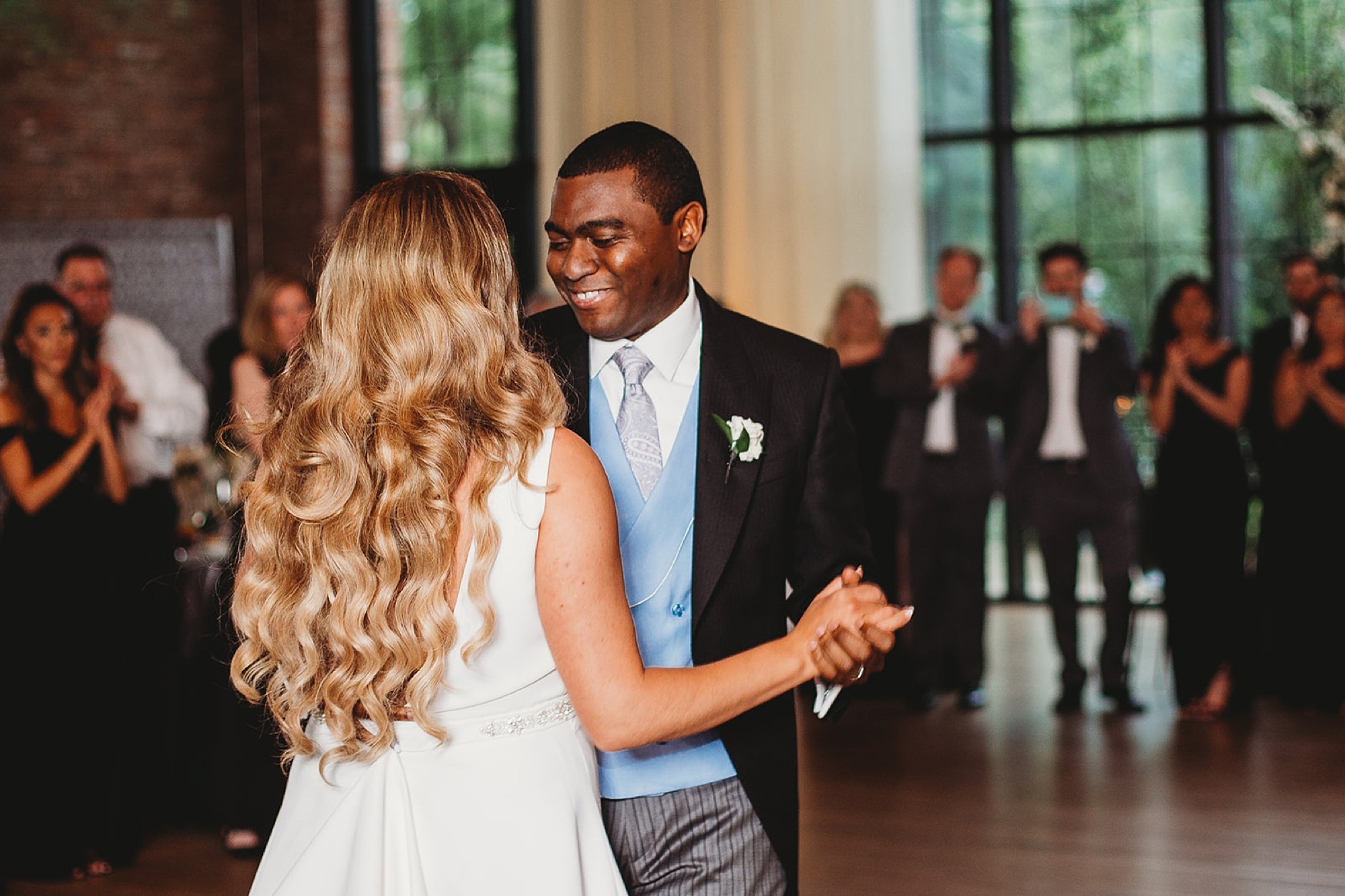 groom smiles at bride during first dance at Beacon NY wedding reception