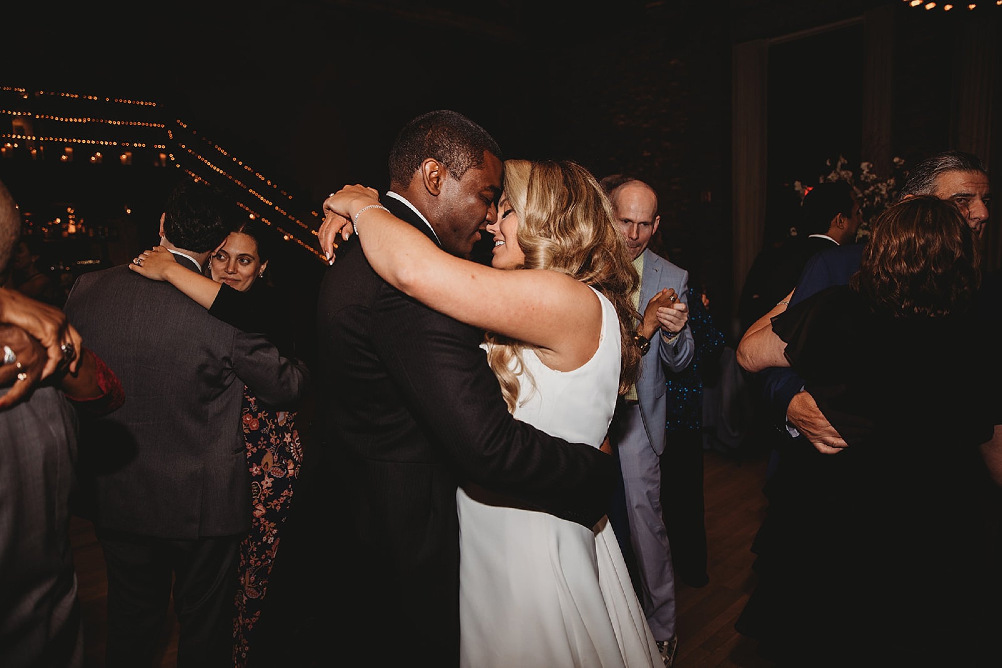 bride and groom hug dancing at end of wedding reception 