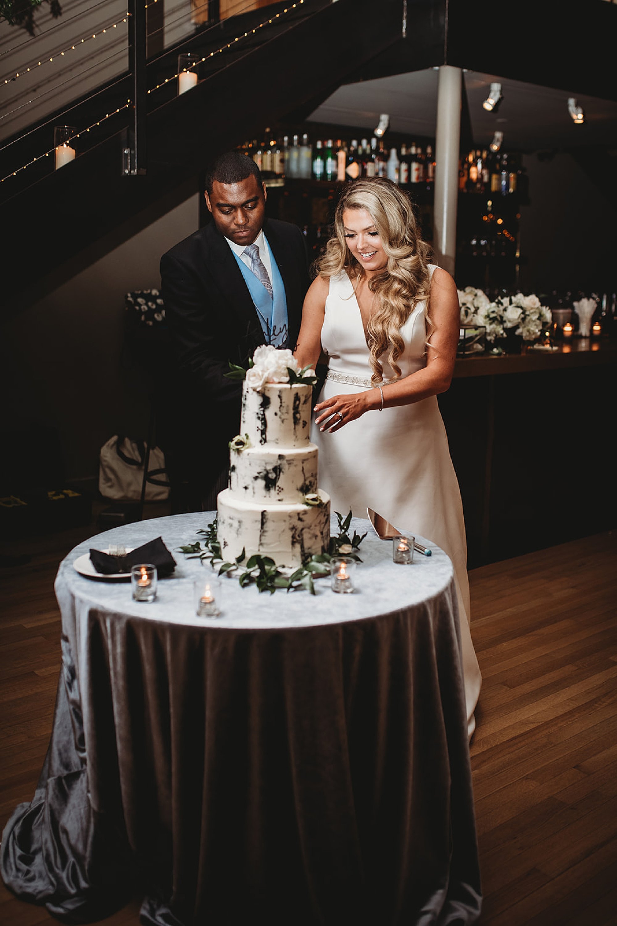 bride and groom cut marbled wedding cake at Beacon NY wedding reception