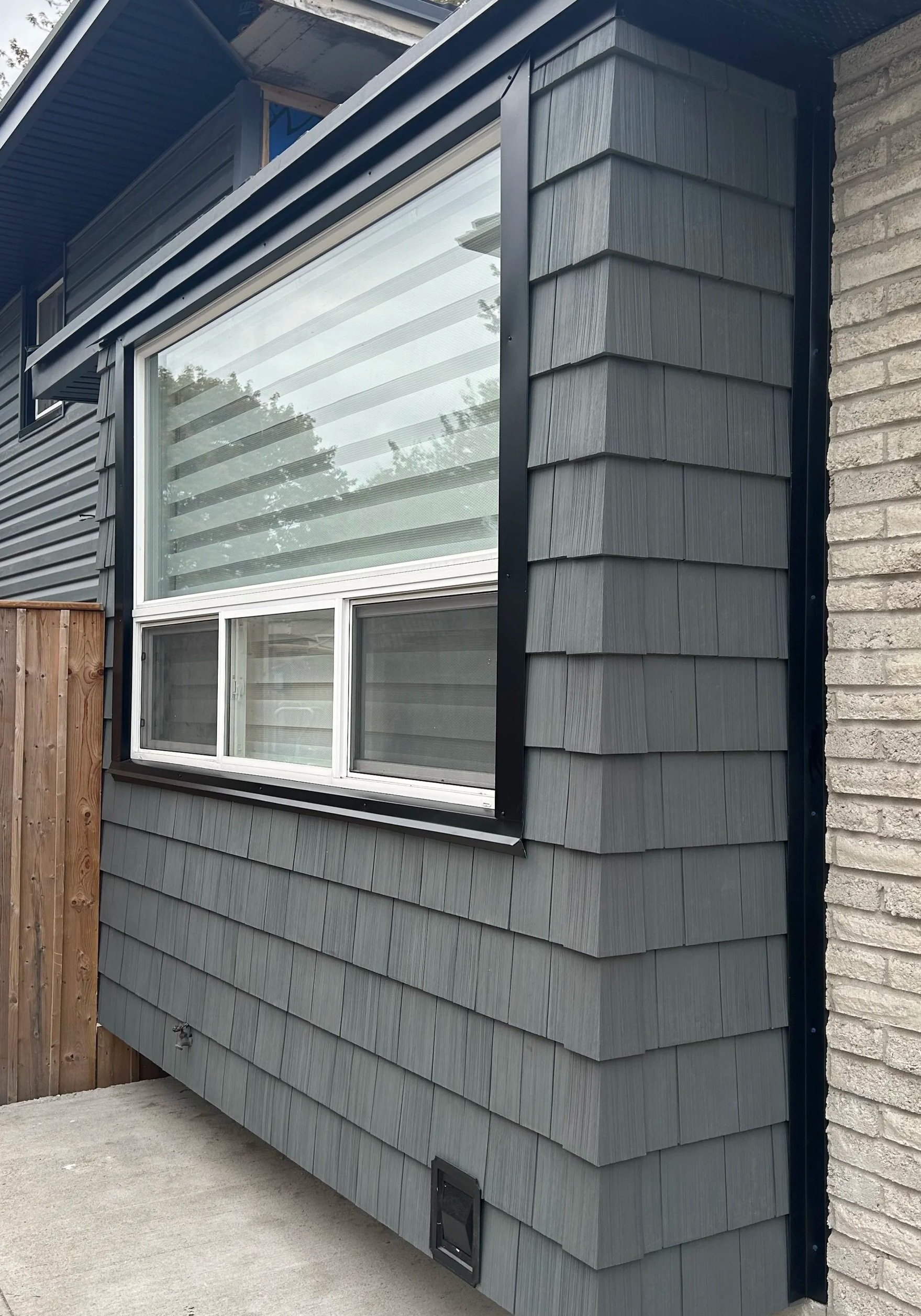Vinyl Siding in a 'shake' style.  Part of a full exterior renovation - soffit, fascia, gutters, and siding.   