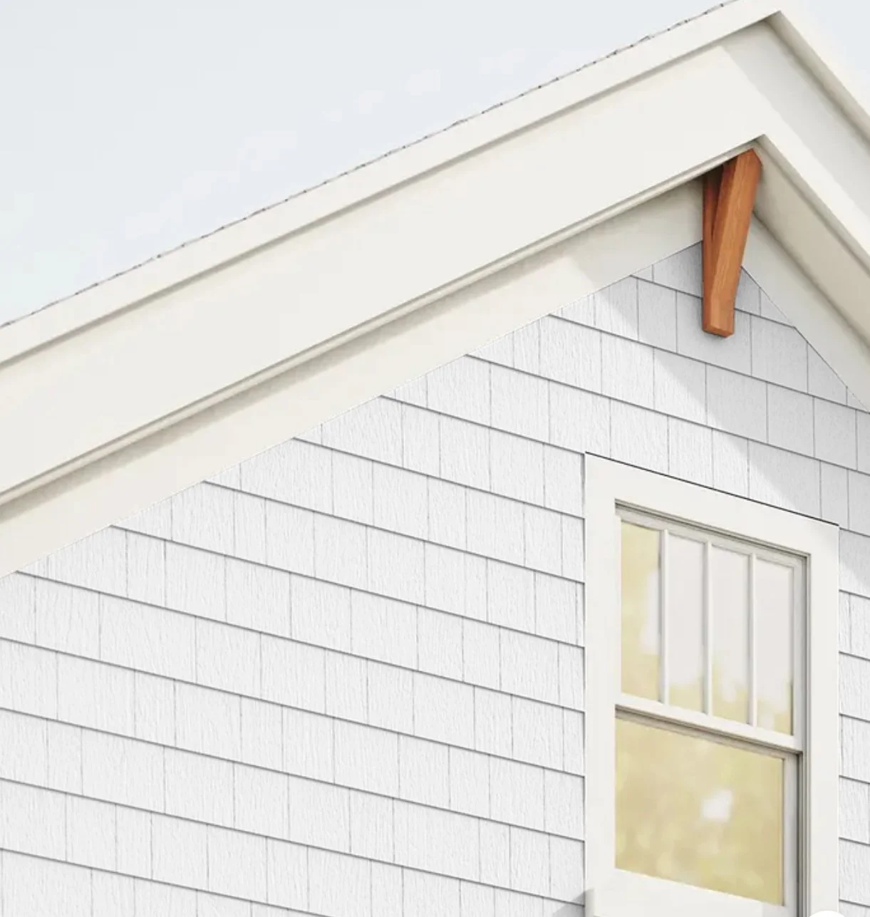 Close-up of a house's exterior corner showing white siding, a window, and part of the roof with white trim and a small wooden support bracket.