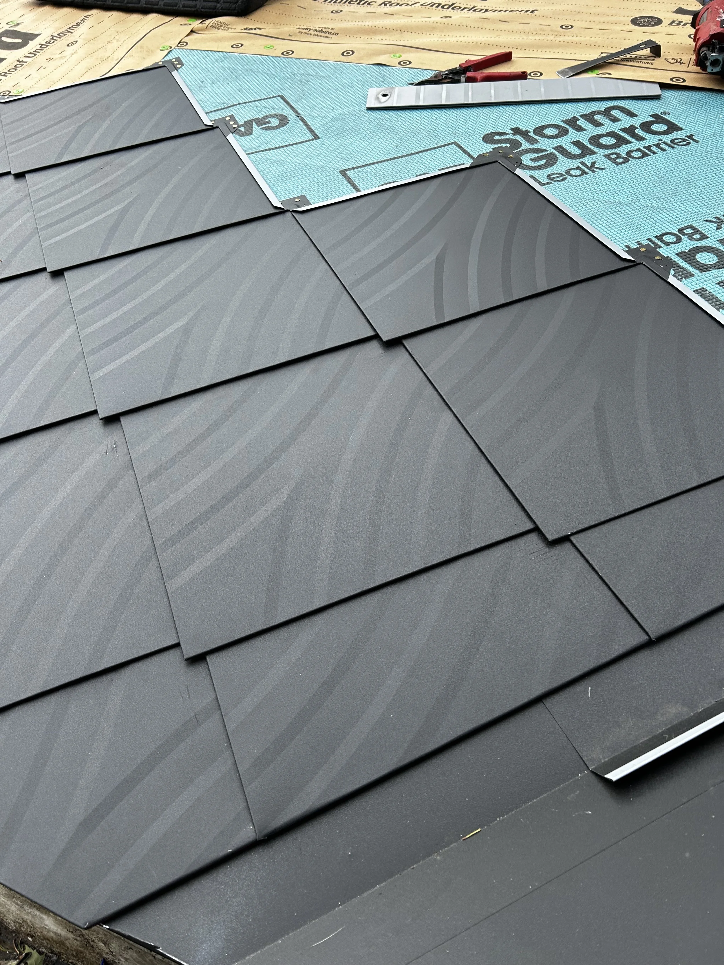 Diamond Steel shingle install close-up.  Colour = 'ebony'.  Wortley Village, London