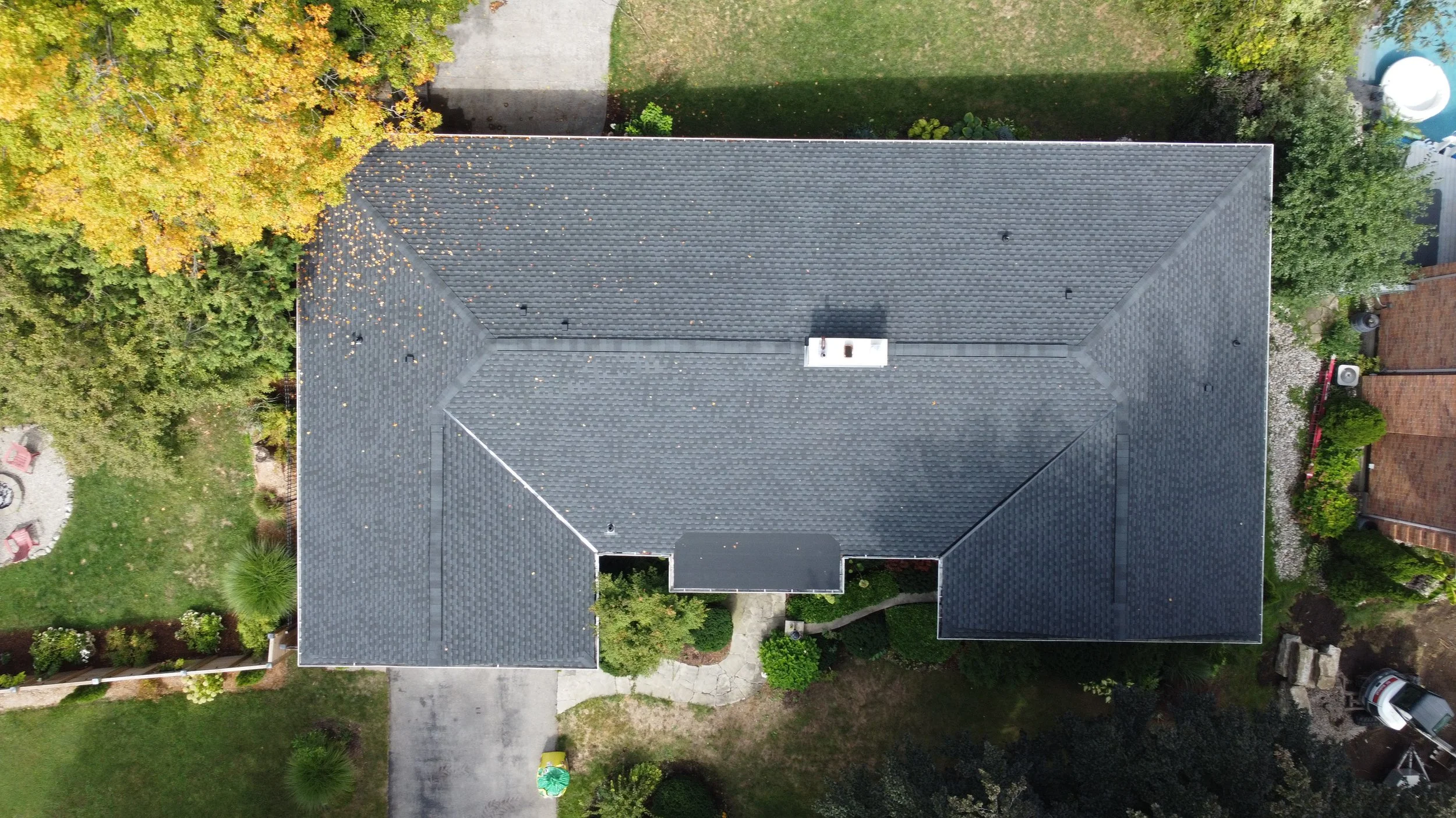 Charcoal Ultra UHDZ shingles from GAF and a small flat roof on this one-story home in Orchard Park.  