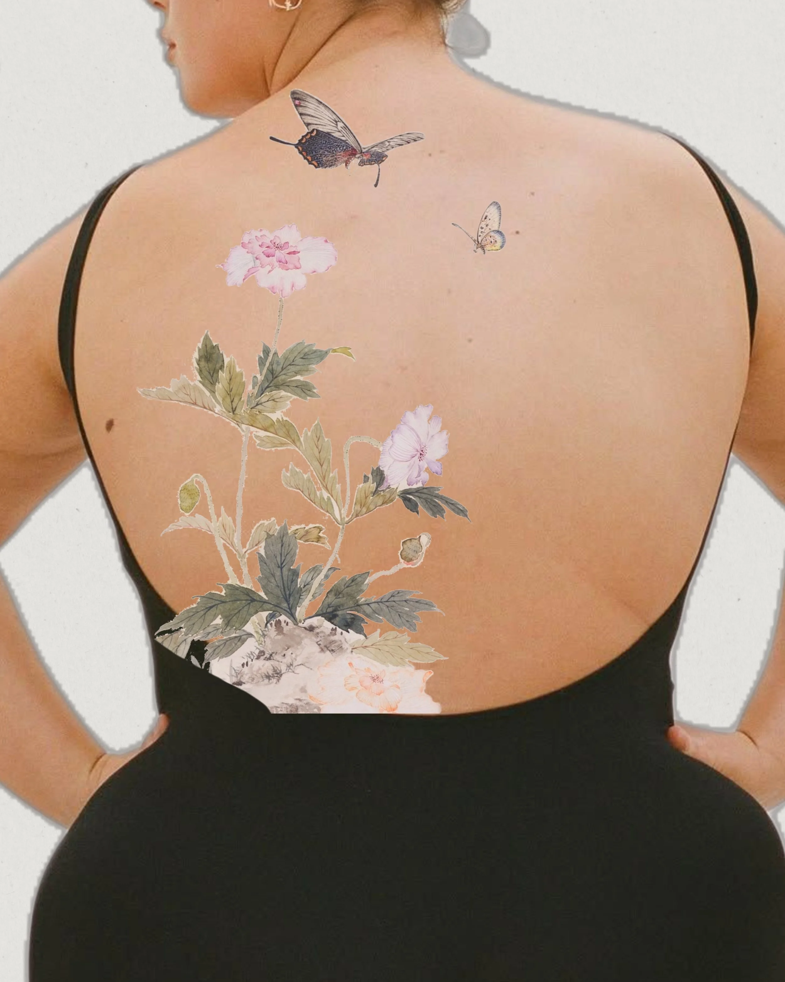 The back of a woman with a floral and butterfly tattoo on her upper back, wearing a black dress with thin straps.