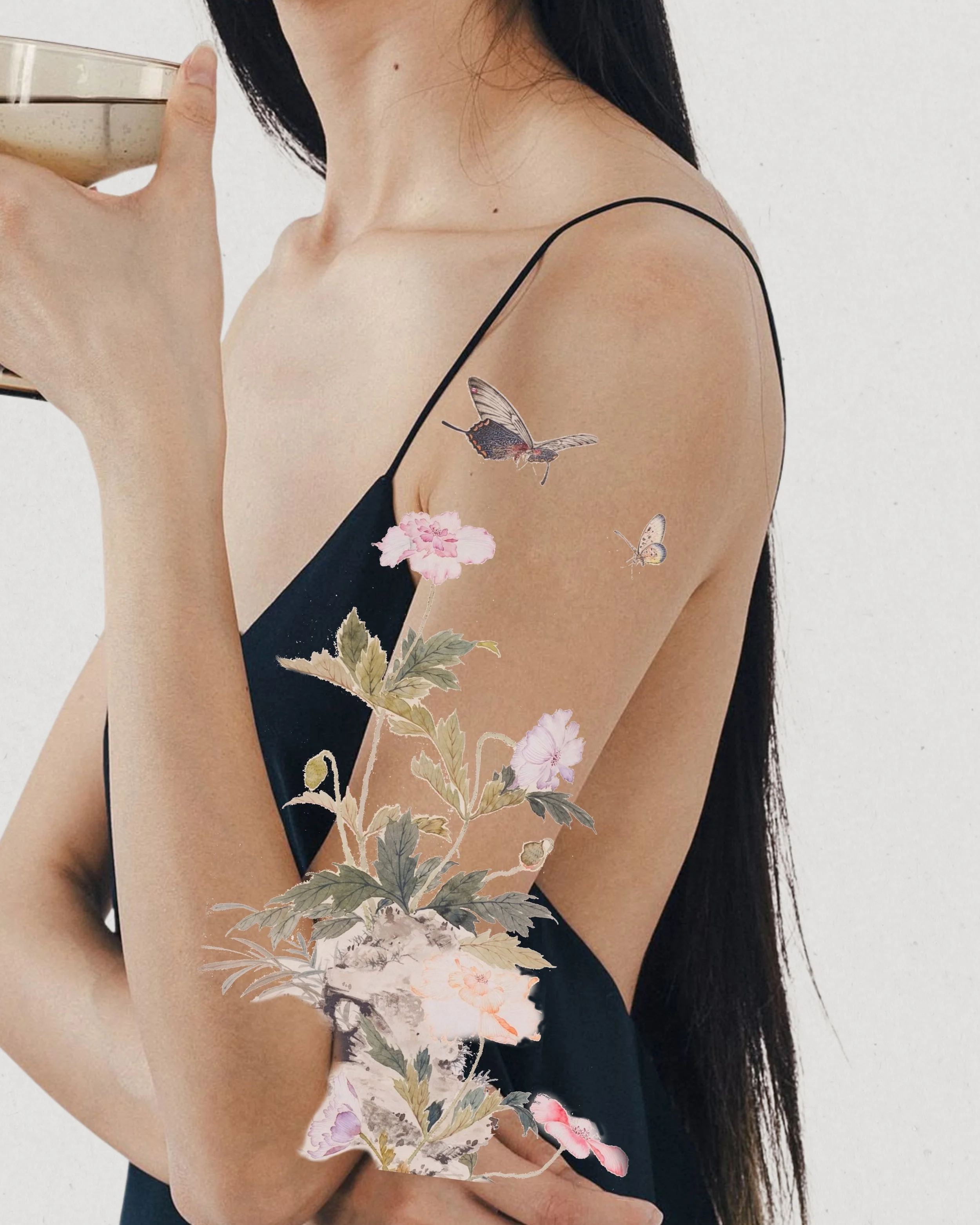 A woman with long dark hair wearing a black spaghetti strap dress holding a drink. There are illustrated flowers and butterflies overlaid on her arm and dress.