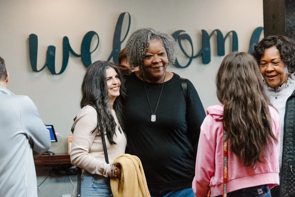 Friendly greeters at the welcome sign inside Cornerstone Church