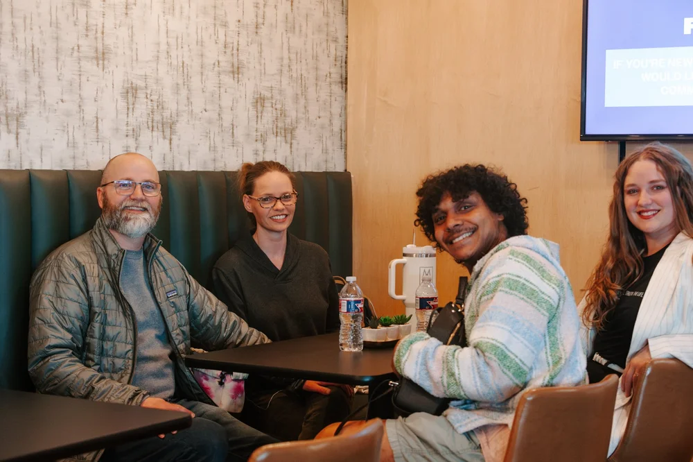 A small group sharing a meal and conversation