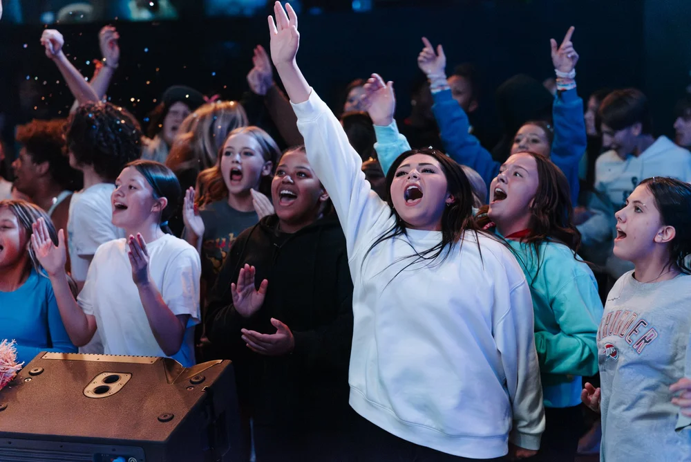 Worshipers with hands raised during a Cornerstone Church service
