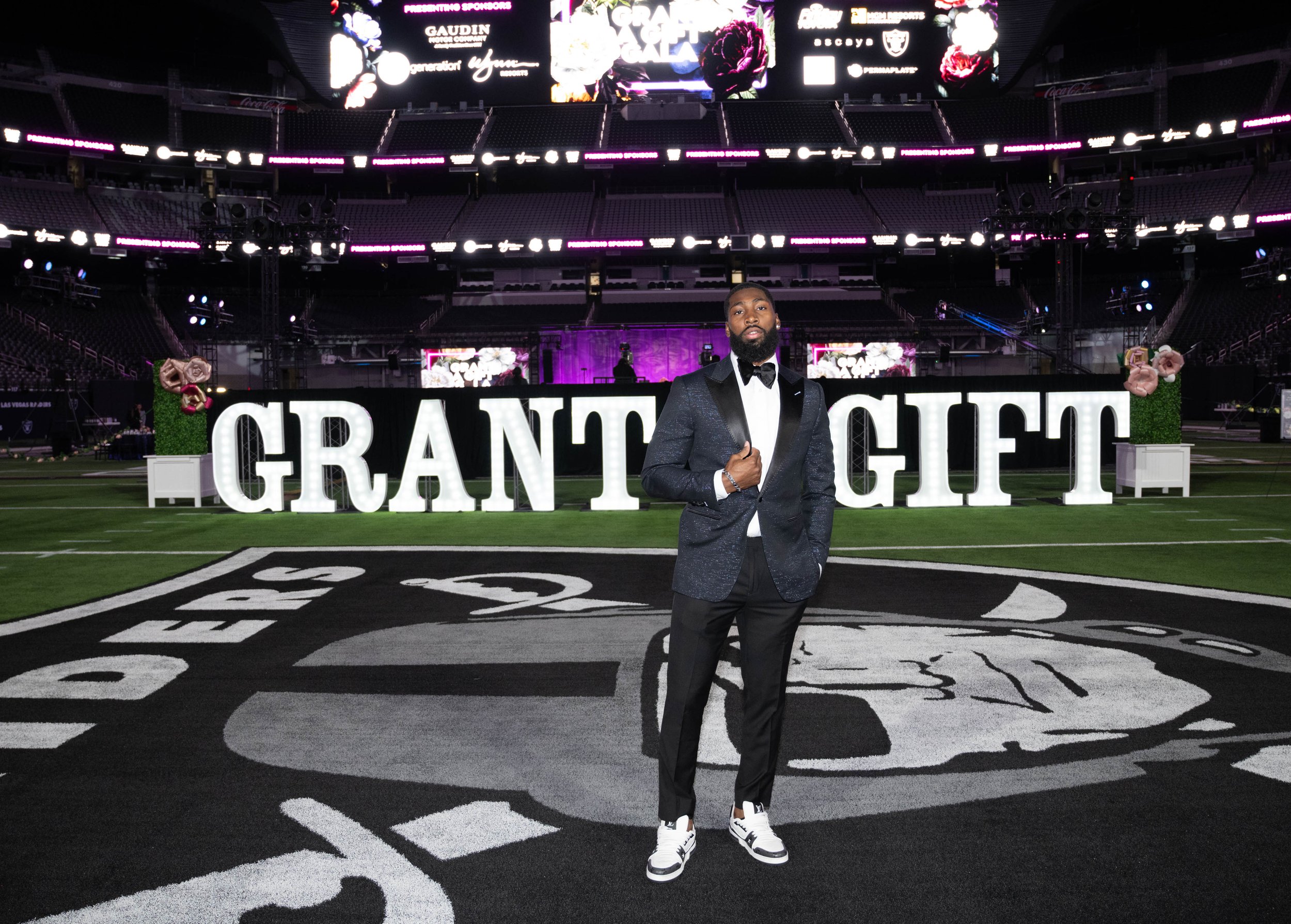 Raiders cornerback Nate Hobbs poses on field of Allegiant Stadium at Grant A Gift Gala Nov. 1, 2023.jpg