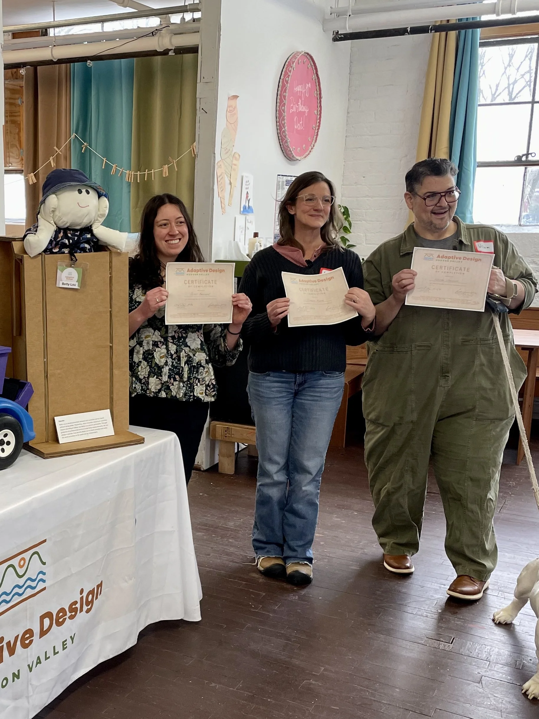 three attendees receive their certificate