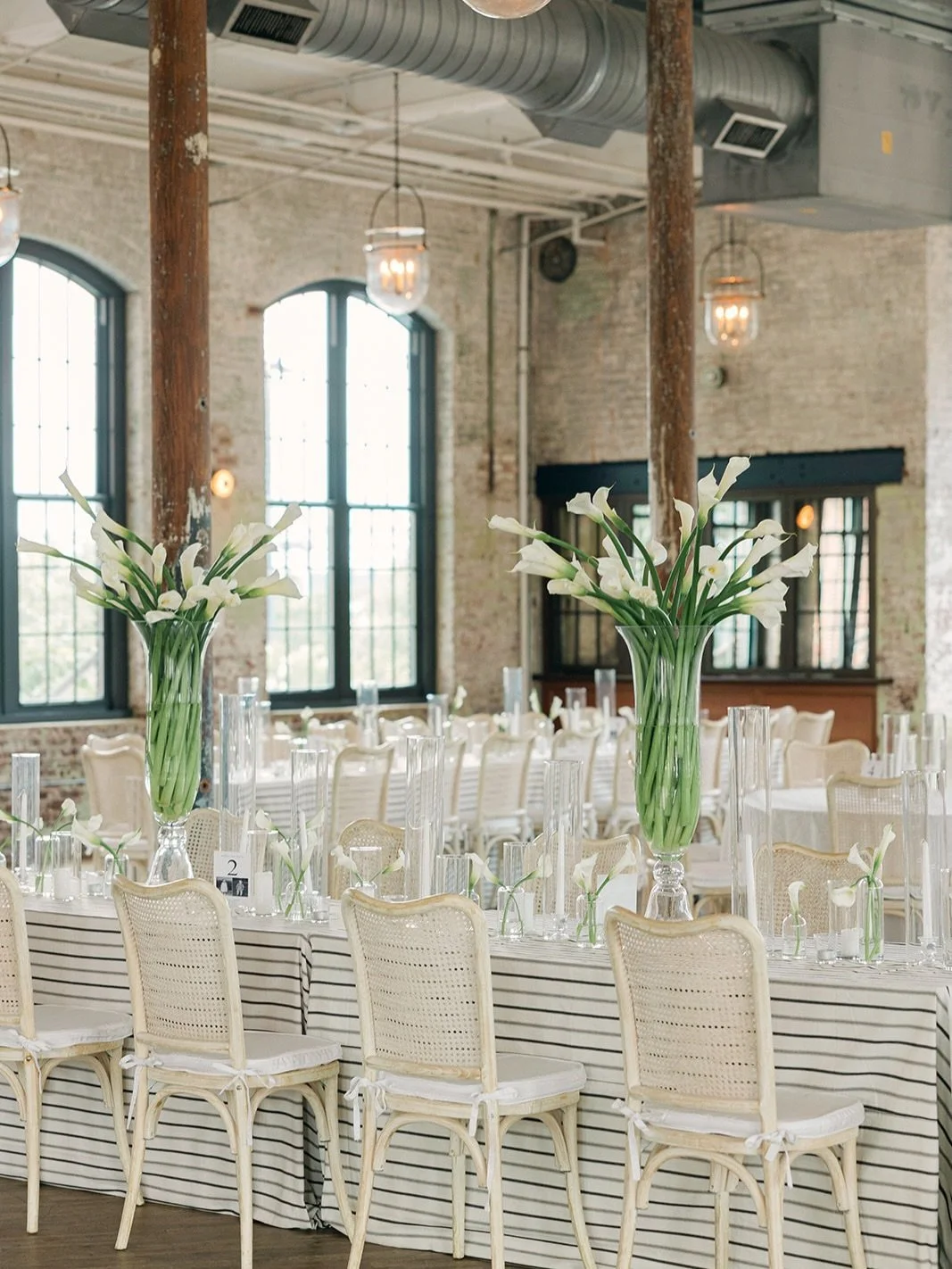 A study in stripes, calla lilies, and candlelight. 🤍
.
.
.
Planning &amp; Design: @grove.designs.co
Photographer: @emmaliliphotography
Venue: @thecedarroomchs
Floral: @wisteriadesigns
Rentals: @eventworksrentals
Linens: @stradleydavidson