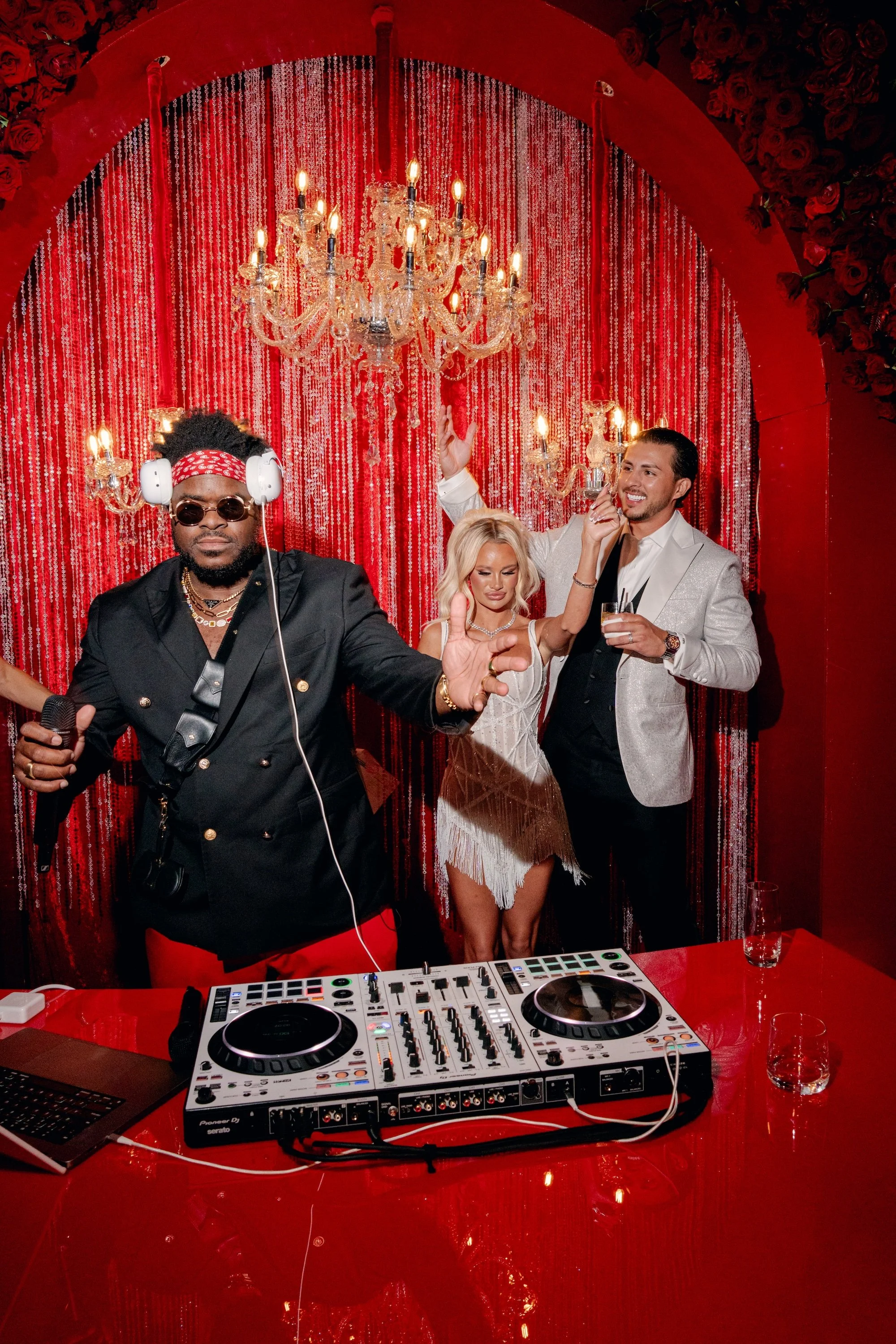 Bride and groom with DJ Malike at a luxe Las Vegas Wedding. Red and black modern wedding reception at Fontainebleau Las Vegas.  Luxury Las Vegas Wedding Planner Andrea Eppolito.