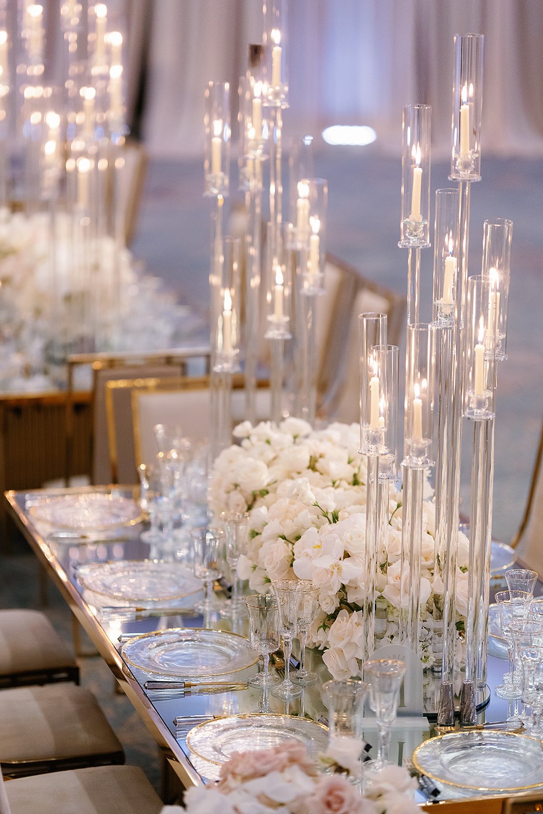 white roses and tall candle centerpieces