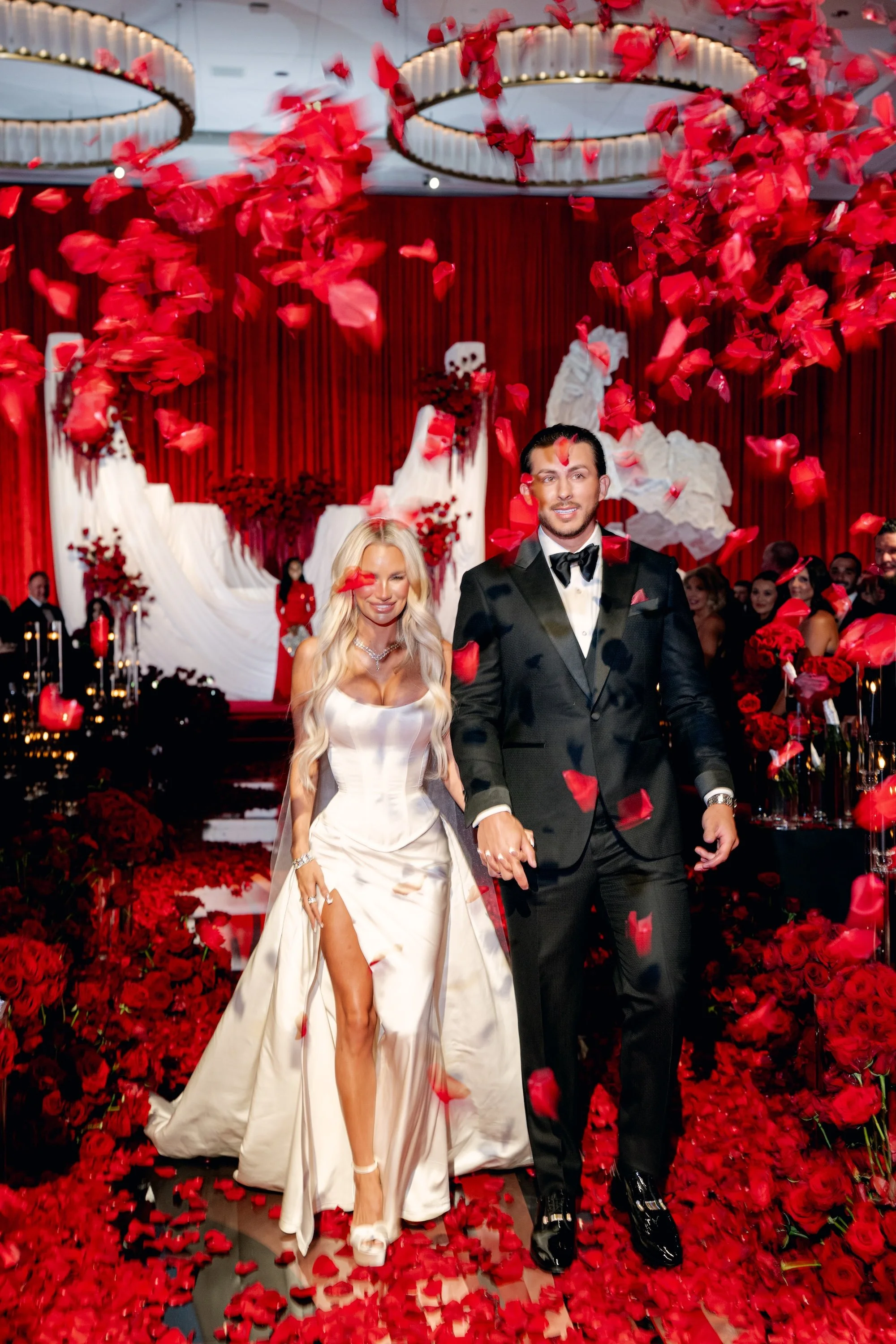 Red rose petals tossed over the bride and groom at luxe, modern red wedding. Luxury Las Vegas Wedding Planner Andrea Eppolito.