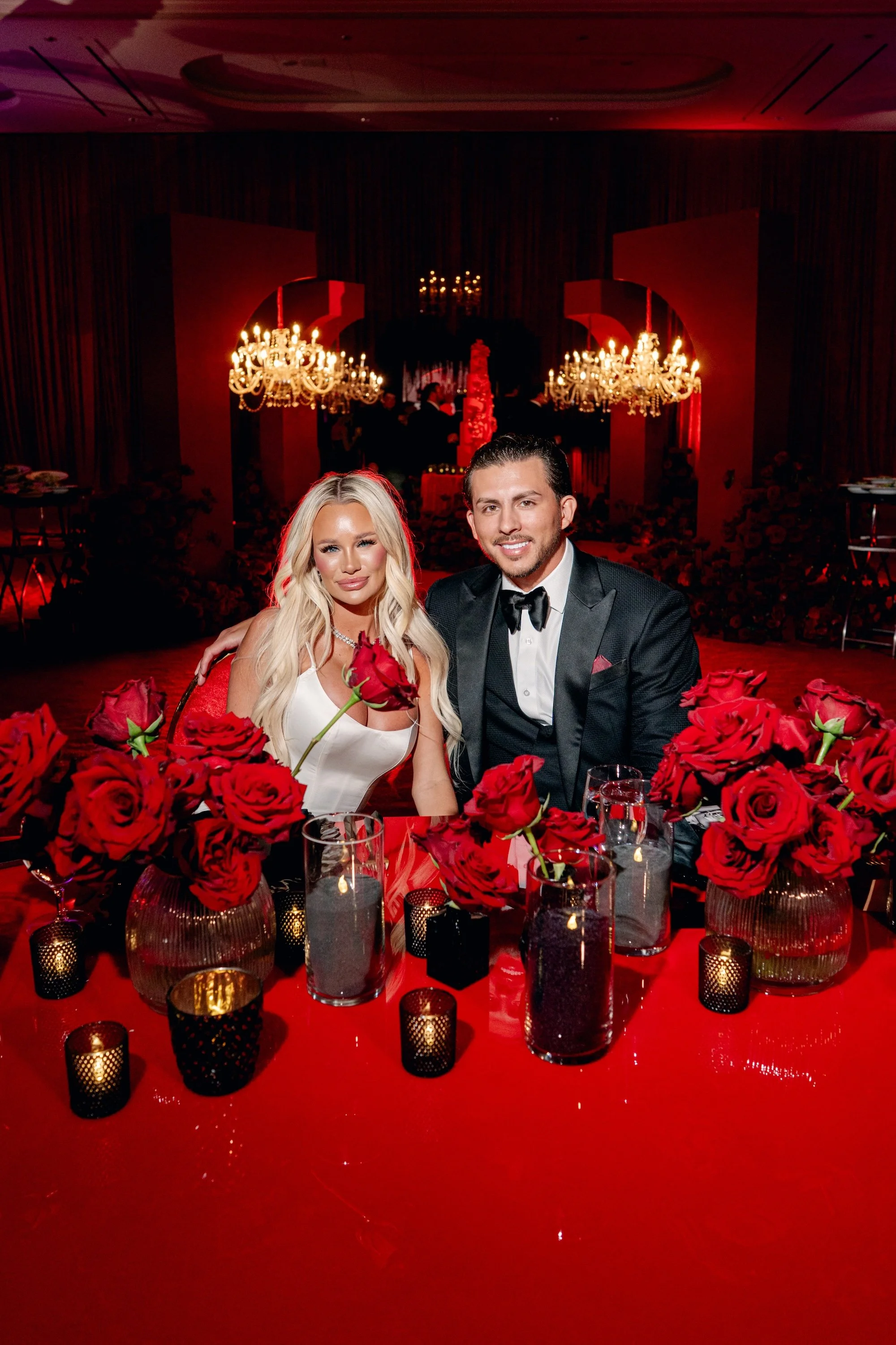 Bride and groom sweetheart table. Red and black modern wedding reception at Fontainebleau Las Vegas.  Luxury Las Vegas Wedding Planner Andrea Eppolito.