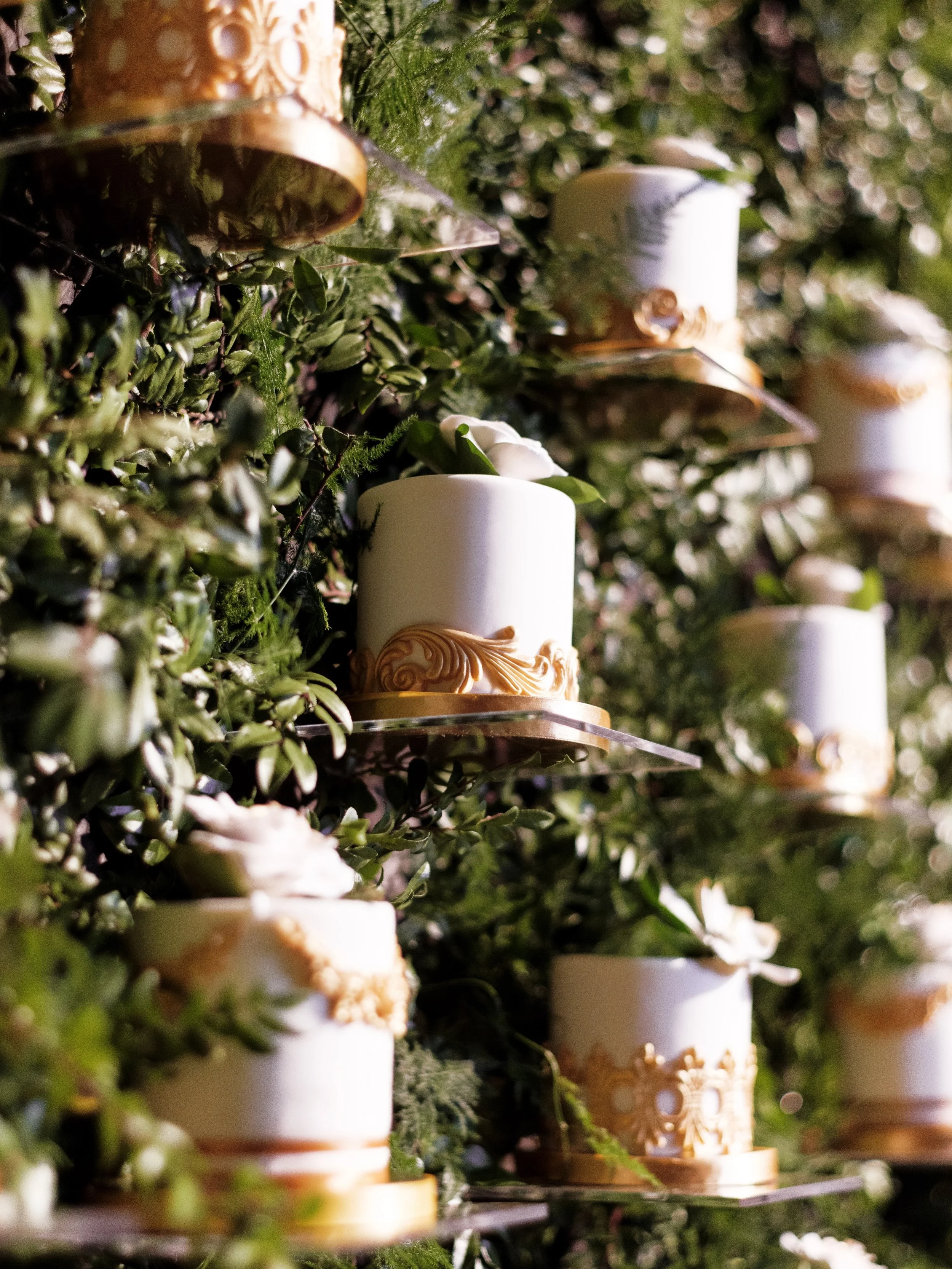 Let them eat (wedding) cake!

Why have one cake when you can have 350?!? 

We had 350 individual floating cakes with three different flavors, accented by slightly different designs. Not only was this a major statement piece that we integrated into th