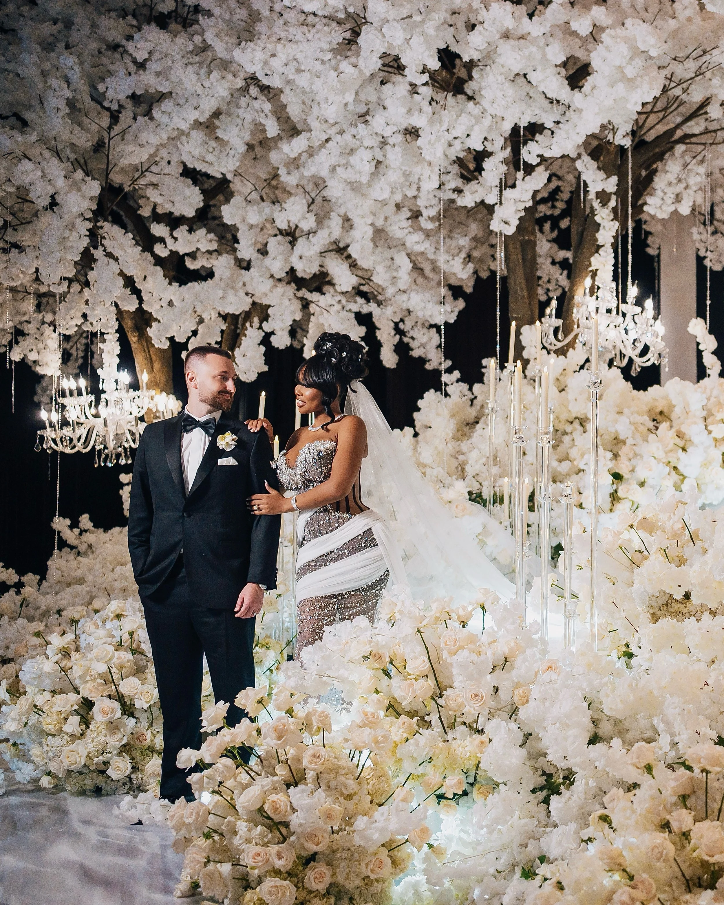 Iconic, romantic, and just a little bit of whimsy. 

A wedding that feel like stepping into another world.

A forest of ivory blossoms. Trees overflowing with flowers. Roses spilling across the floor. Crystal, candlelight, and layers upon layers of s