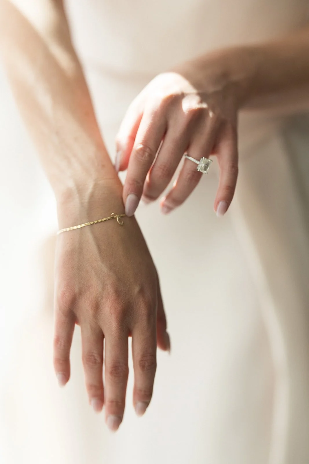 Bride's Hands Putting on Jewelry