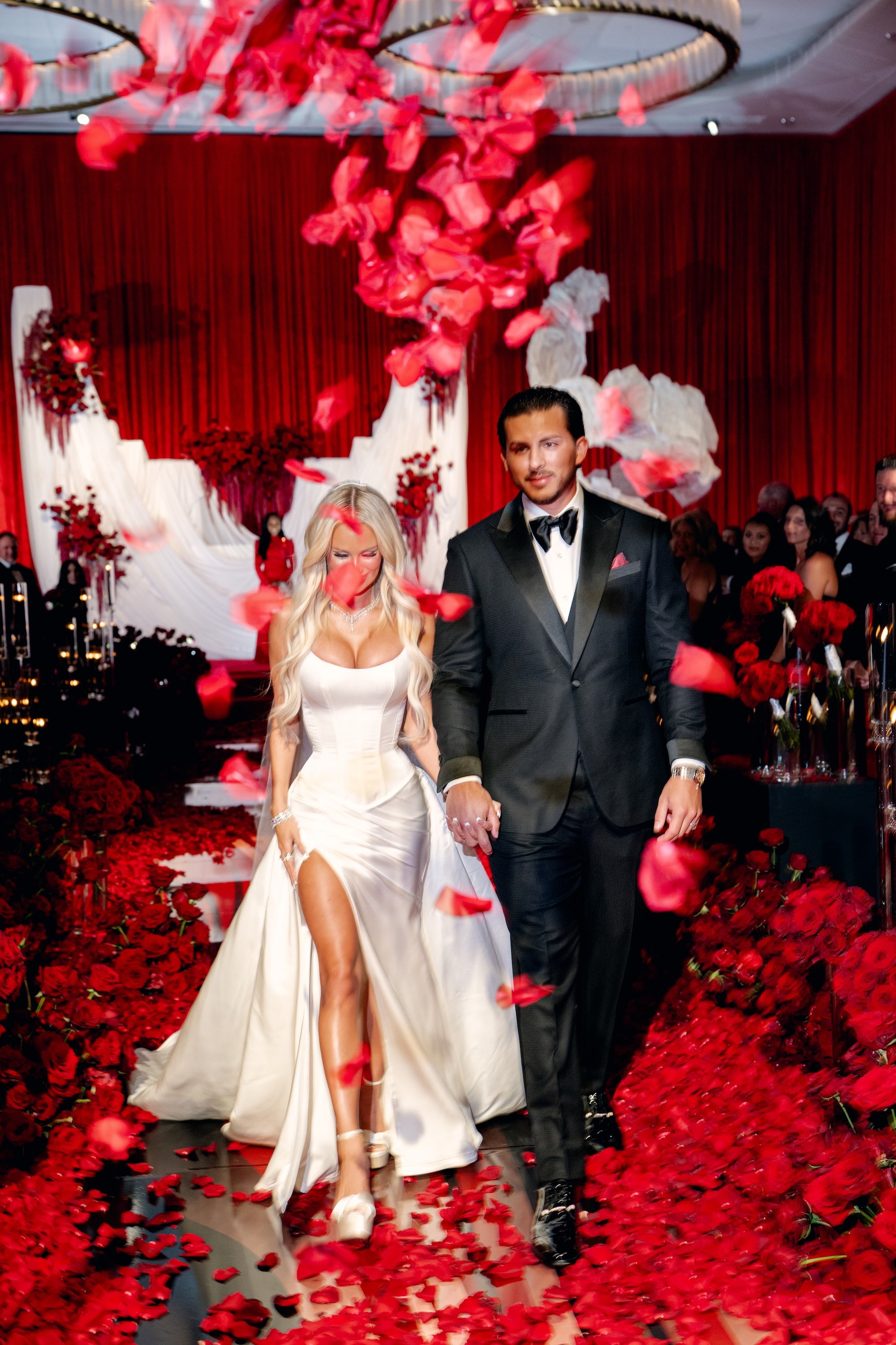 Bride and groom leaving their wedding ceremony. Red and black modern wedding reception at Fontainebleau Las Vegas.  Luxury Las Vegas Wedding Planner Andrea Eppolito.