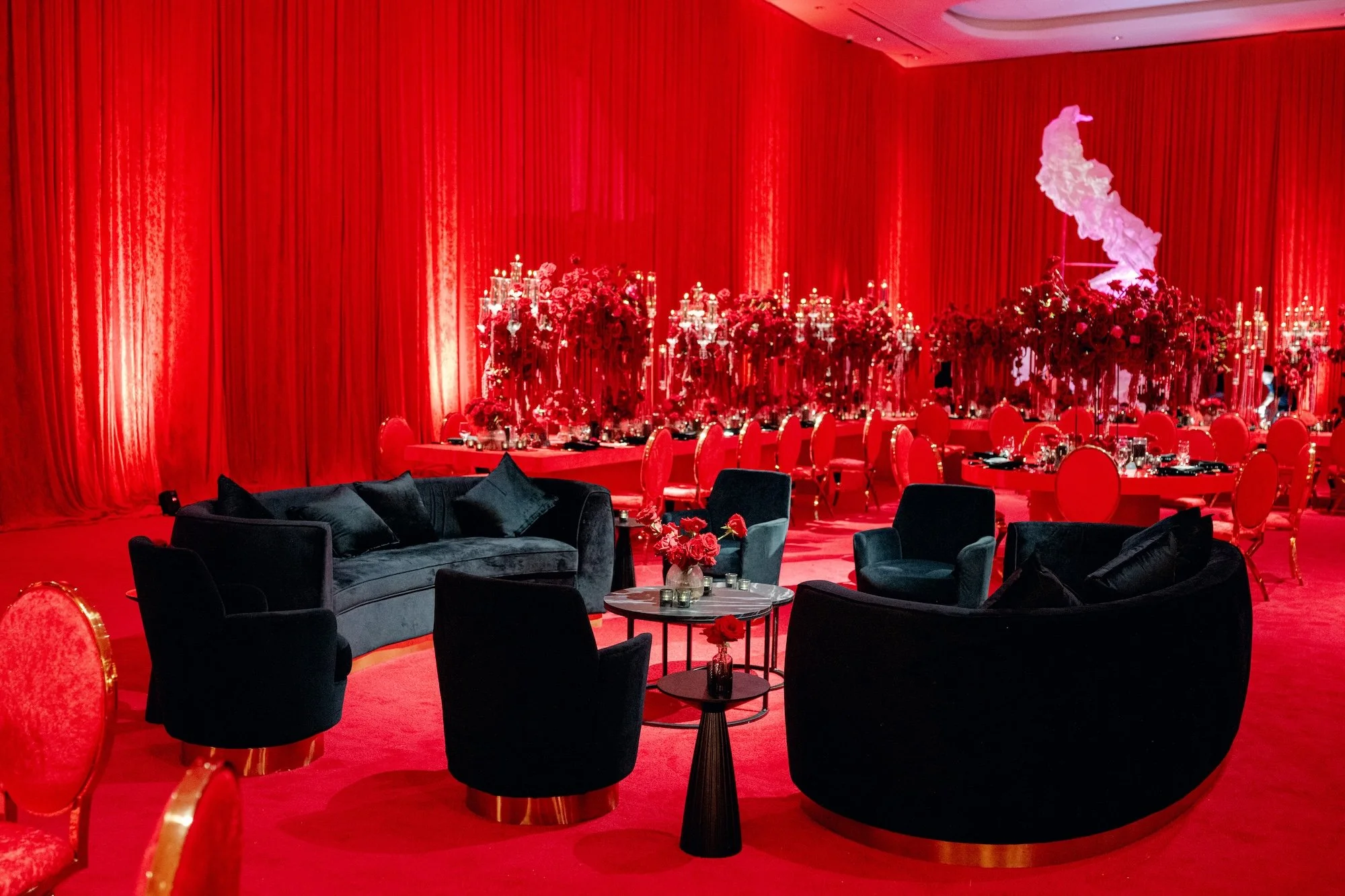 Black velvet lounge furniture at red luxury wedding. Red and black modern wedding reception at Fontainebleau Las Vegas.  Luxury Las Vegas Wedding Planner Andrea Eppolito.