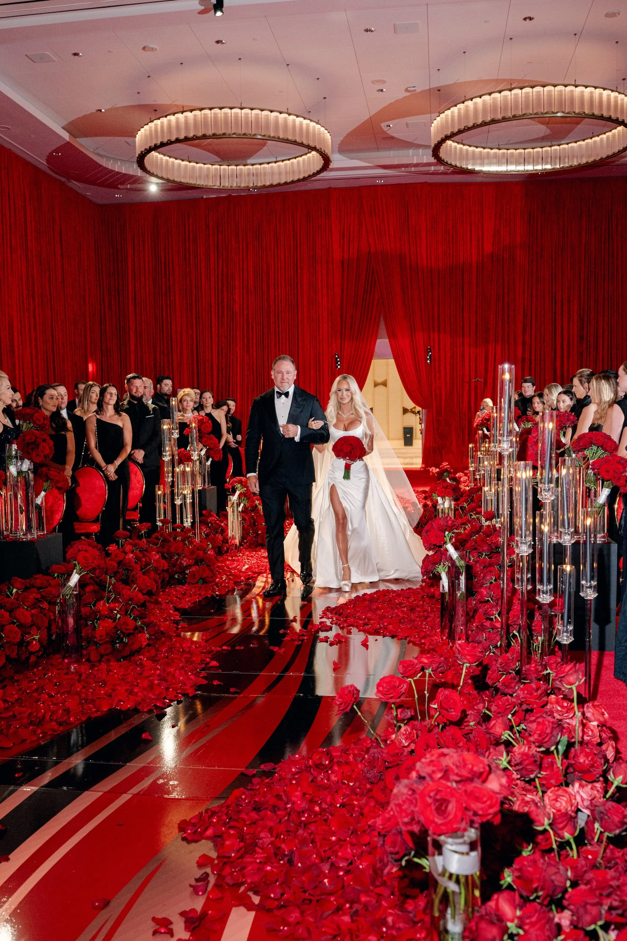Bride being walked down the aisle by her father at luxe and modern red wedding. Luxury Las Vegas Wedding Planner Andrea Eppolito.
