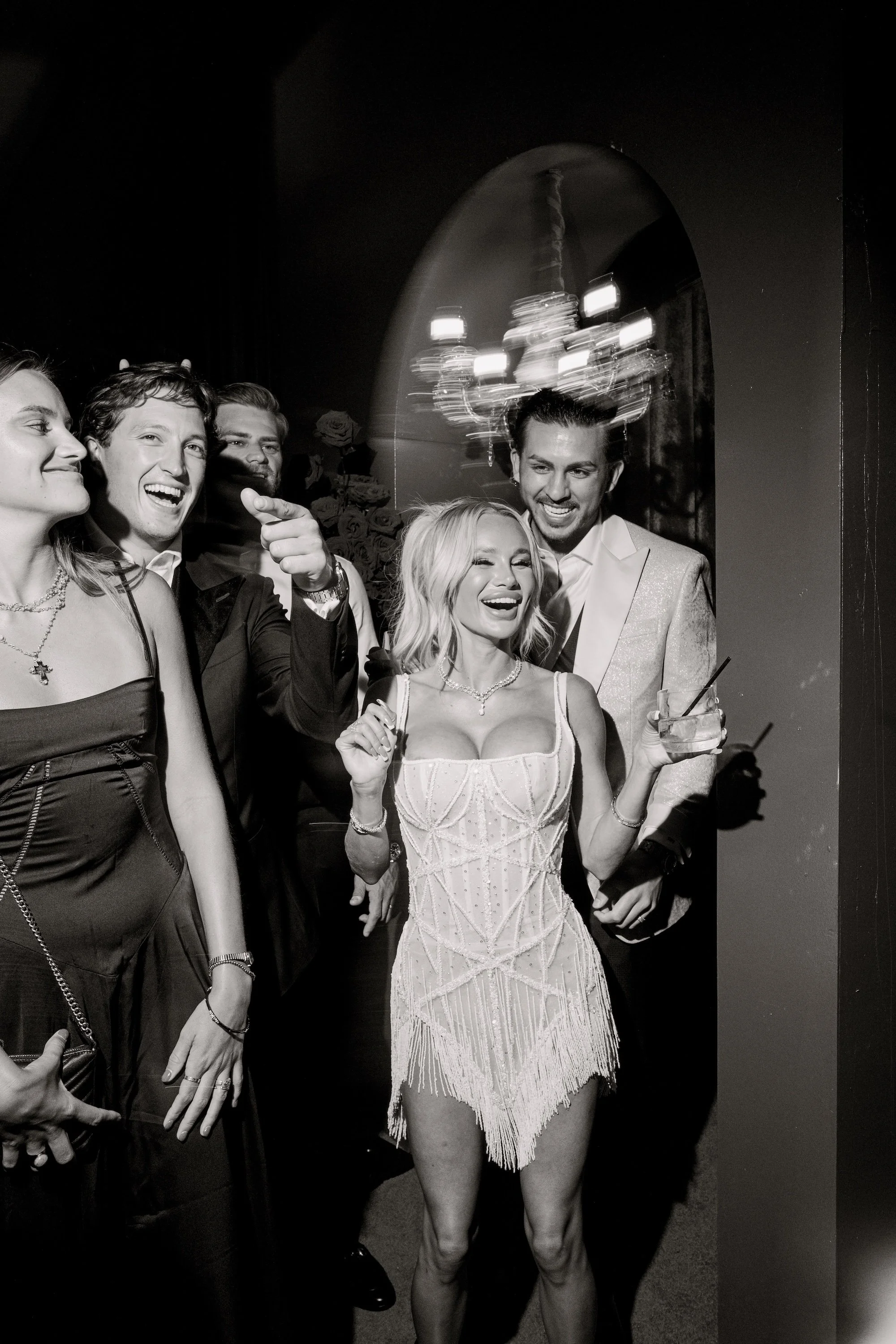 Bride and groom on stage with with DJ Malike at a luxe Las Vegas Wedding. Red and black modern wedding reception at Fontainebleau Las Vegas.  Luxury Las Vegas Wedding Planner Andrea Eppolito.
