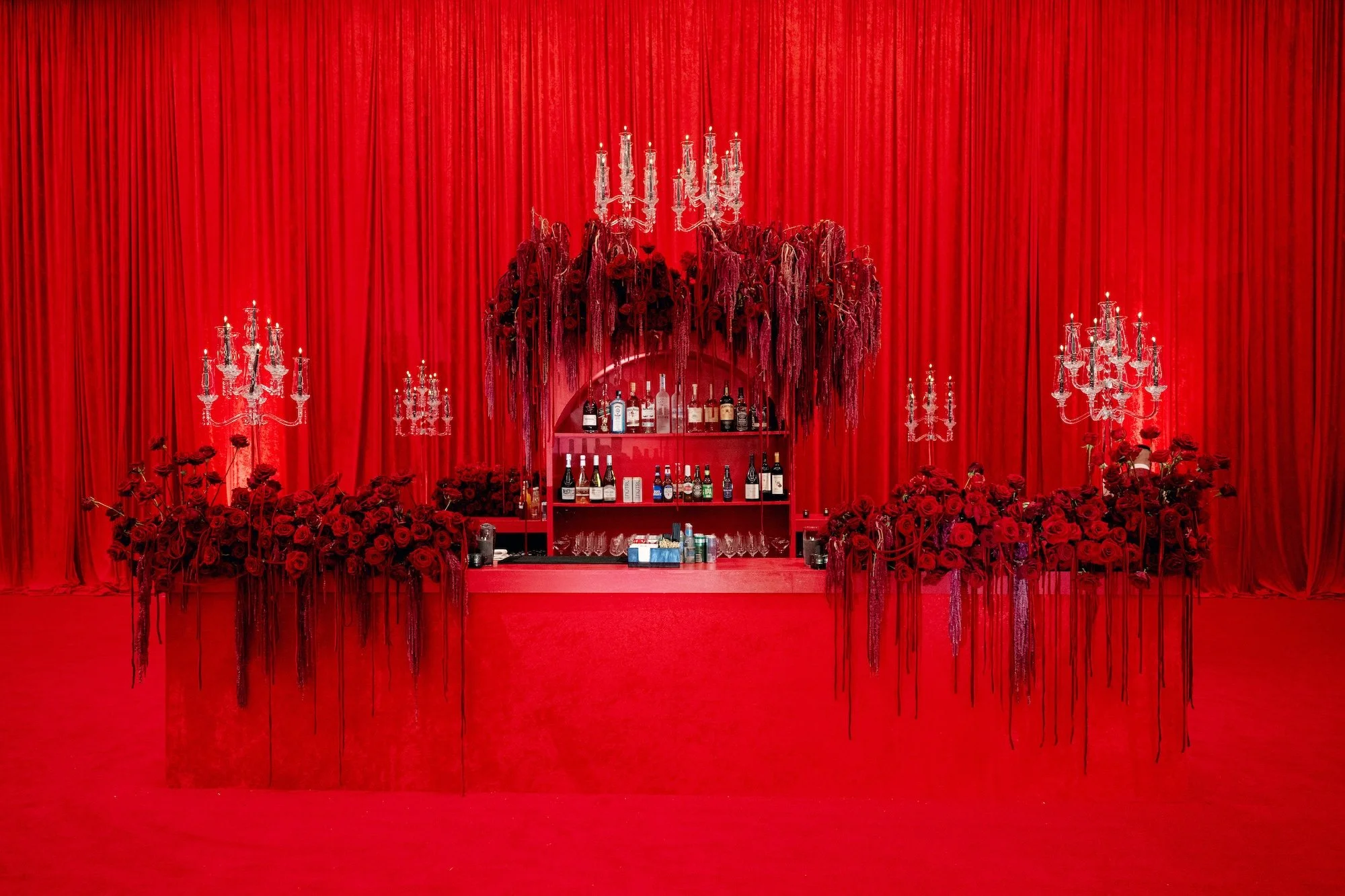 Sexy red hot bar with candelabras and roses. Red and black modern wedding reception at Fontainebleau Las Vegas.  Luxury Las Vegas Wedding Planner Andrea Eppolito.