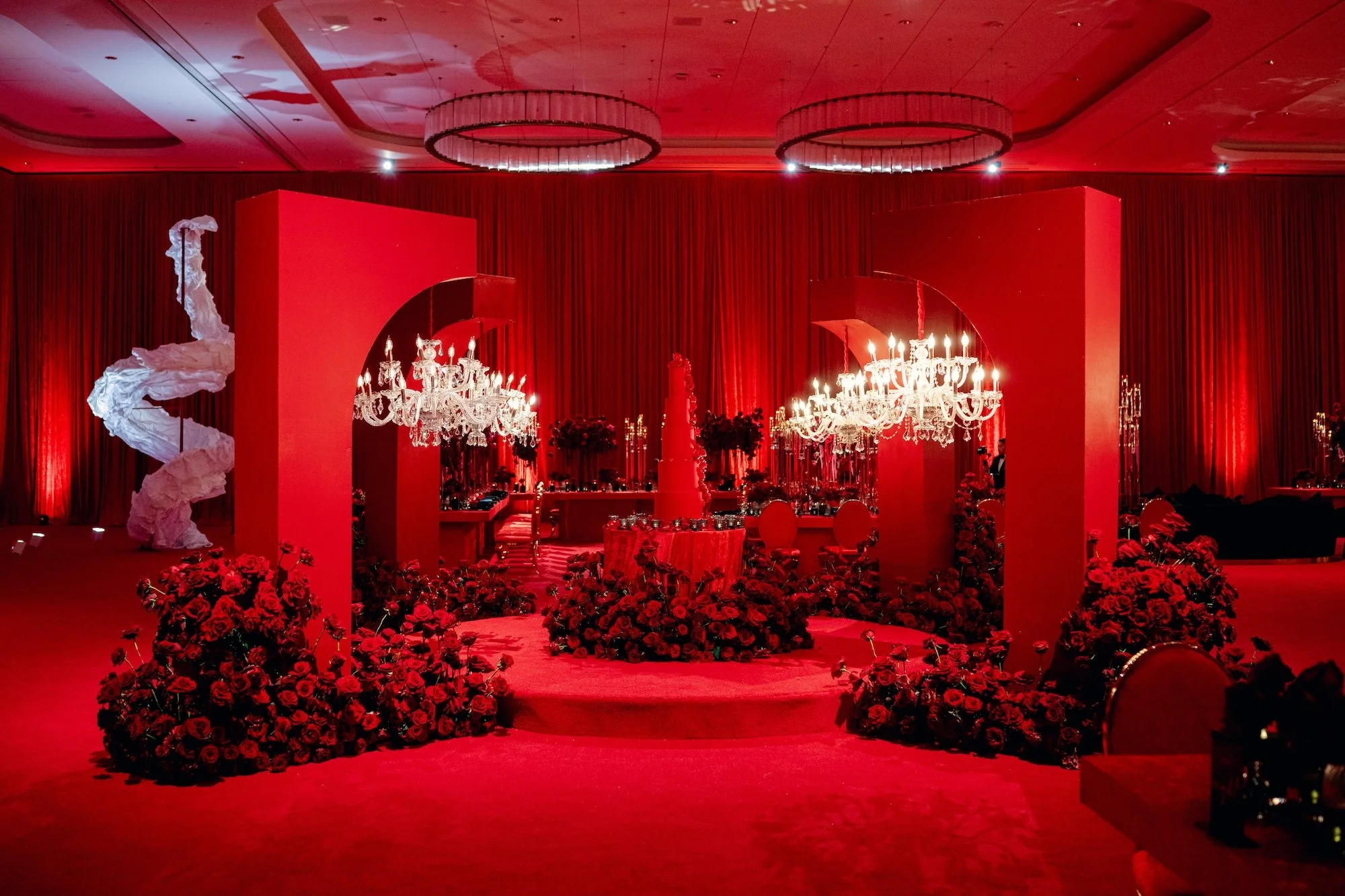 Red on red wedding cake set up with chandeliers. Red and black modern wedding reception at Fontainebleau Las Vegas.  Luxury Las Vegas Wedding Planner Andrea Eppolito.