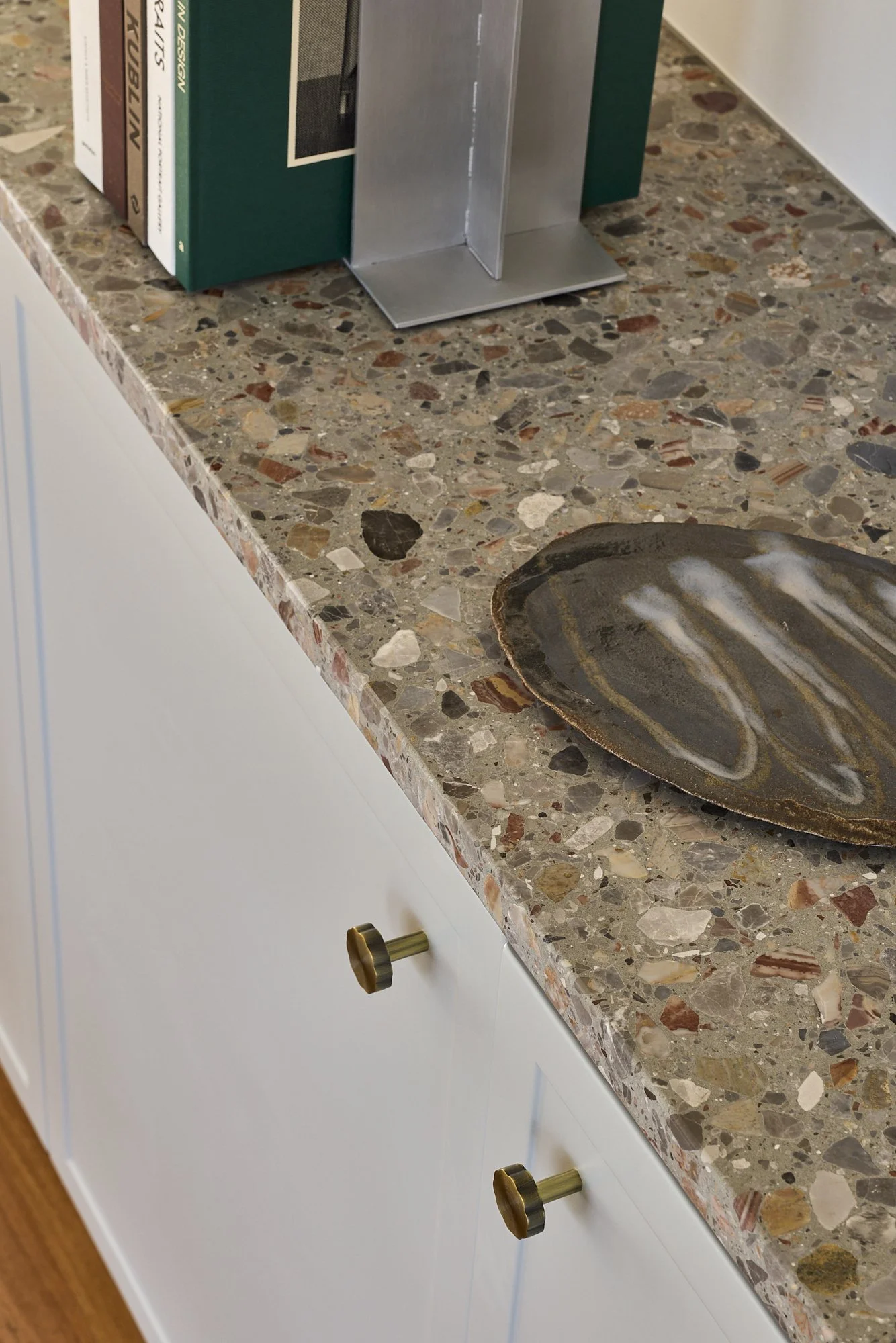 Custom kitchen appliance cabinet with roller door, pale blue joinery, terrazzo benchtop and handcrafted tiled island showcasing bespoke Australian joinery design.vvvv