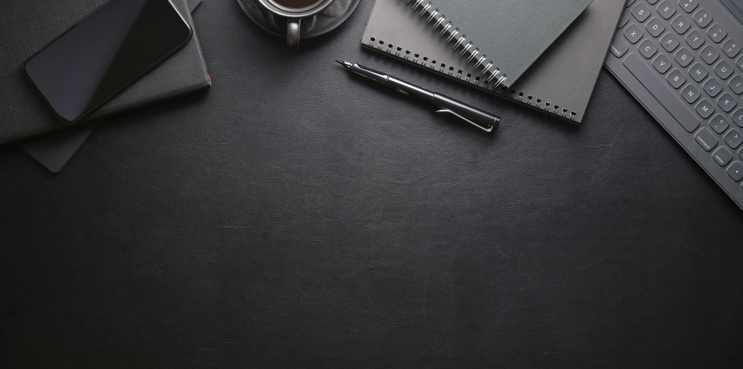 top-view-dark-stylish-workplace-with-smartphone-office-supplies.jpg