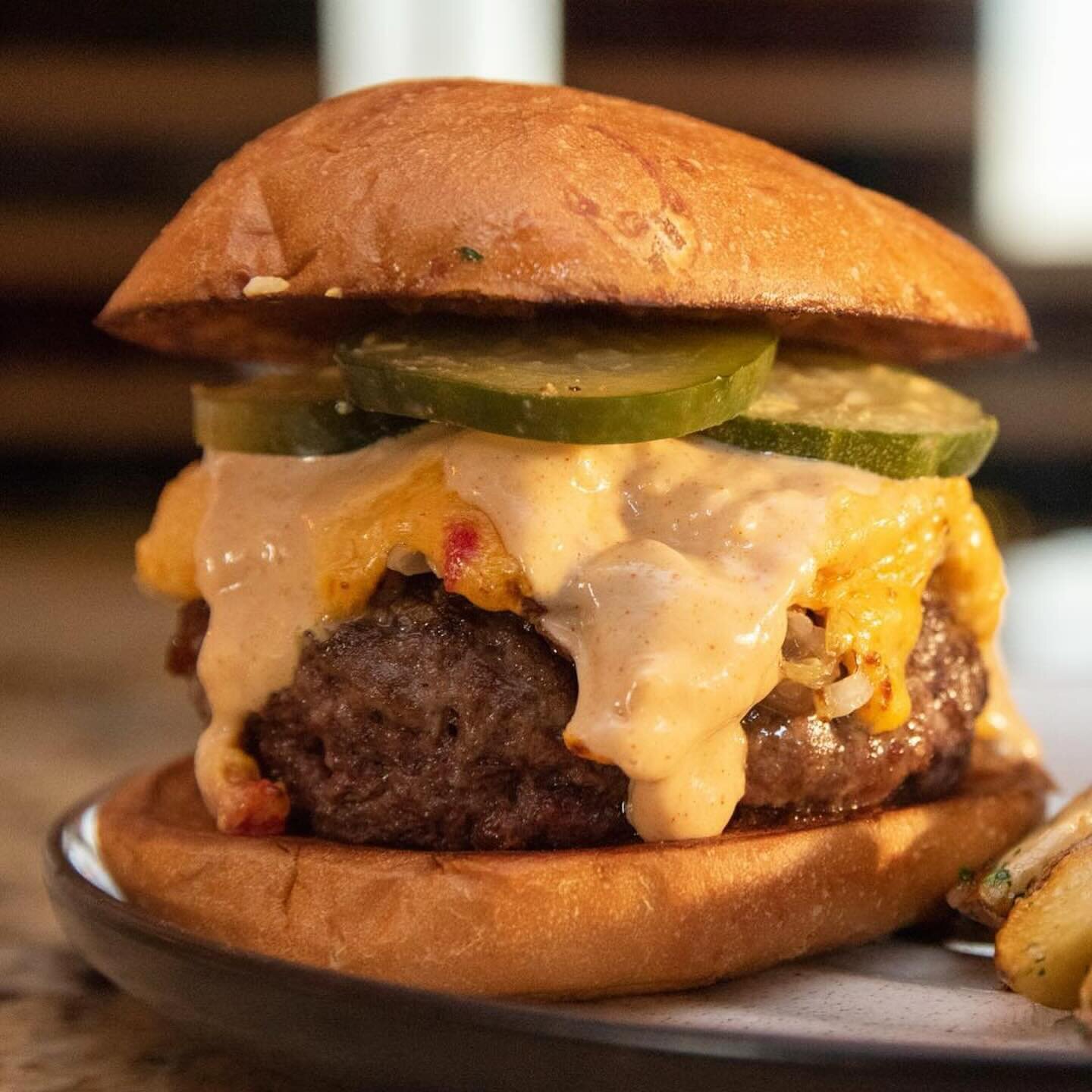 The Bouquet Burger! 8oz of @black_hawk_farms beef, pimento cheese, melted onions, saurkraut and pickles.  Served with sauteed fingerling potatoes.