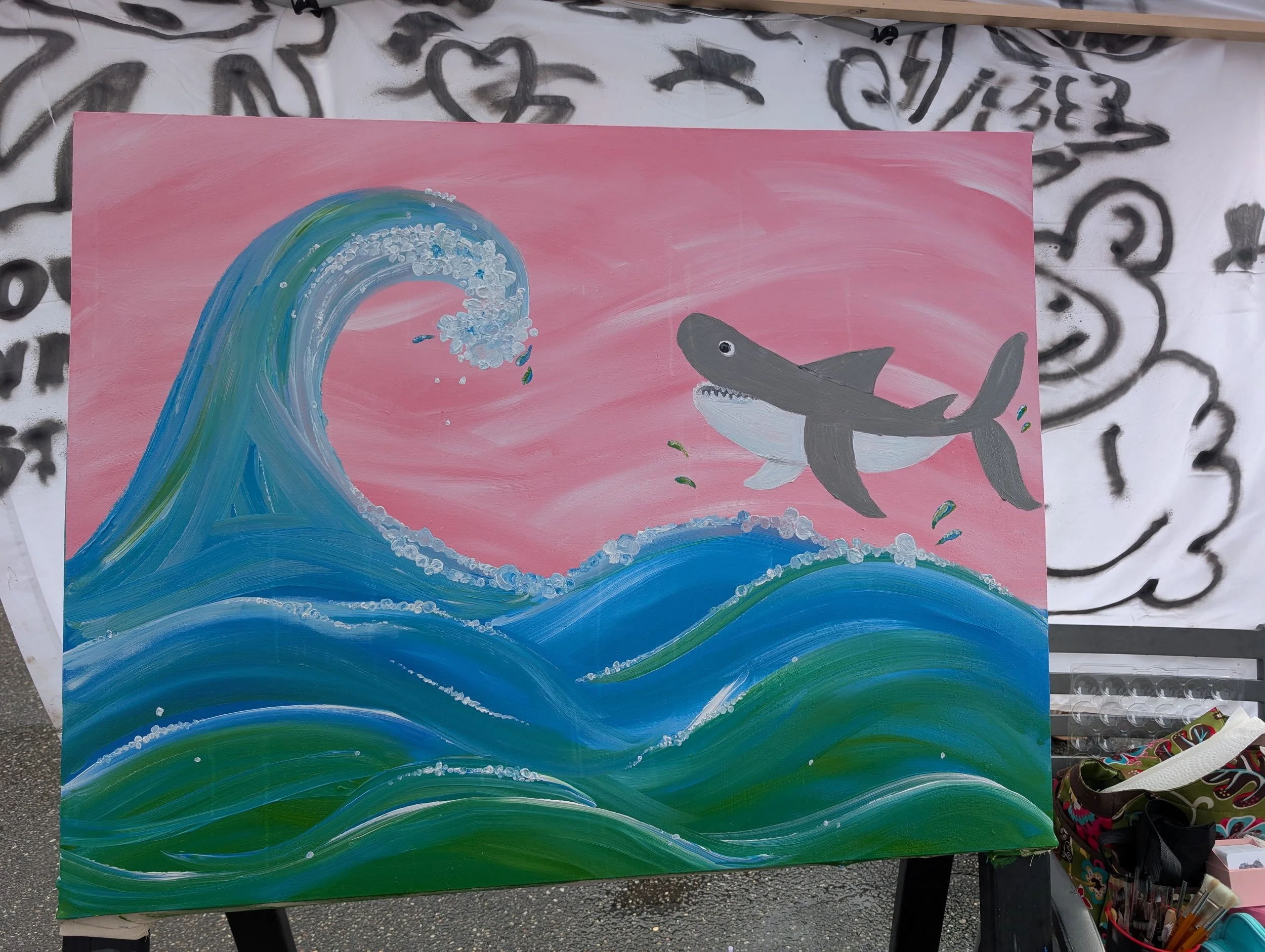 Shark jumping in front of pink sky over blue - green water with wave coming towards him