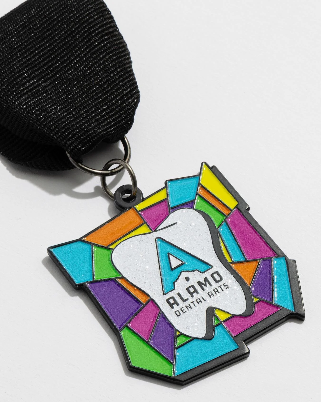 Core Creative brought Alamo Dental Arts&rsquo; &ldquo;stained glass&rdquo; vision to life for the 2026 Fiesta medal. Vibrant Fiesta colors and a white glitter tooth complete a design that will make you smile! #fiesta2026 #fiestamedals #vivafiesta @al