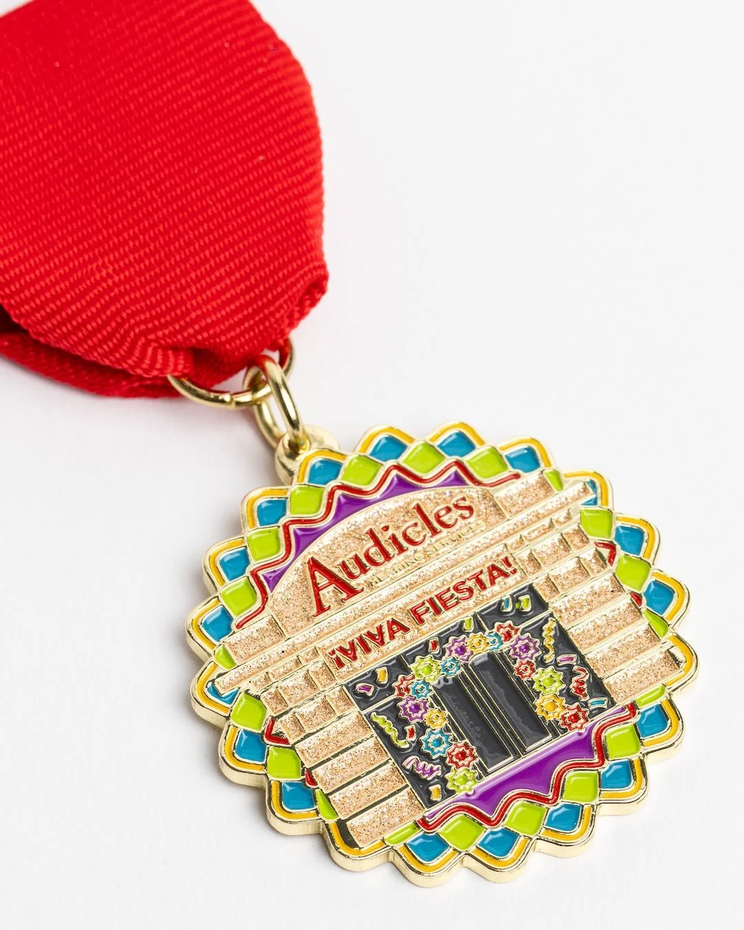 Core Creative designed a custom Fiesta medal for Audicles featuring the hearing healthcare services company&rsquo;s new Alamo Ranch location. Adorned with sparkling sand-tone glitter and a festively dressed doorway, it&rsquo;s proof that great design