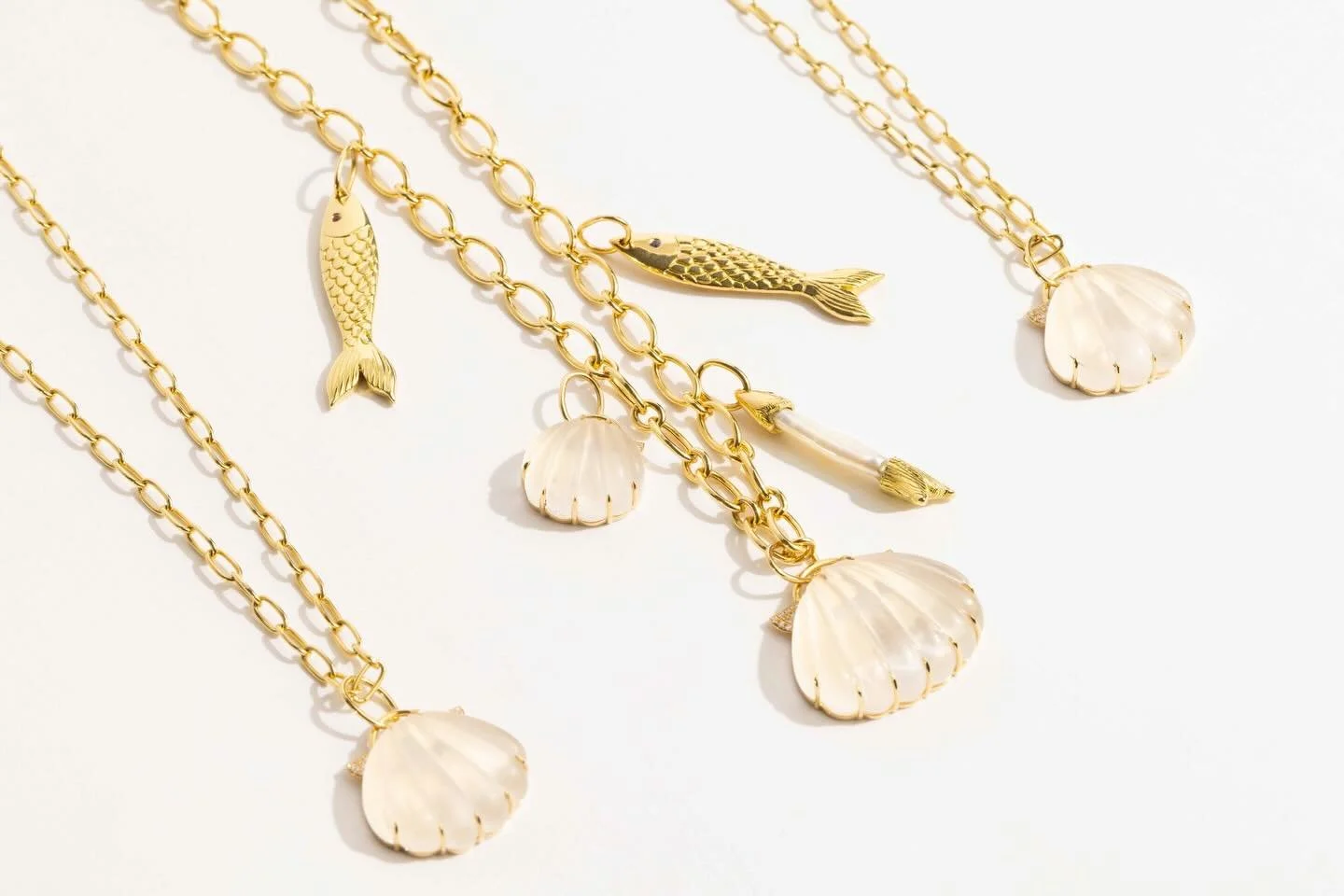 Core Creative Photography recently captured new treasures from @fannie_thomas_jewelry. From beachy, nautical-inspired pieces in soft, colorful hues to delicate earrings, a graceful bird necklace, and a luminous pearl strand finished with a floral cla