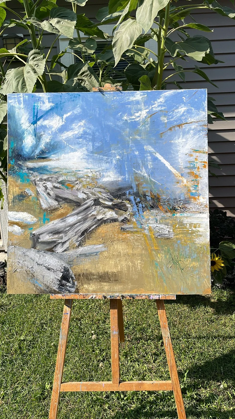The day I completed the painting in the comfort of my backyard, with the backdrop view of my sunflowers.  