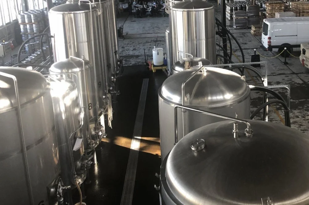 Stainless steel production tanks on a manufacturing floor
