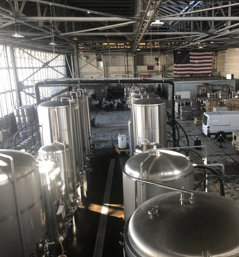 Production floor with stainless steel tanks in a Bay Area manufacturing facility