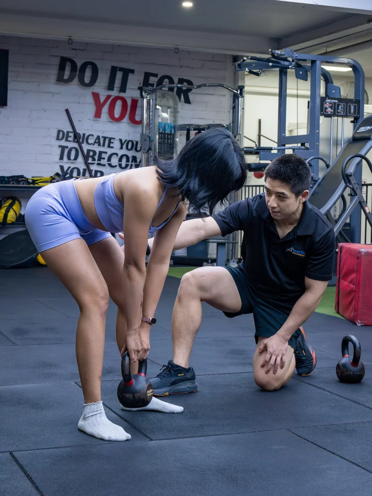 Coaching a kettlebell lift as part of exercise rehabilitation
