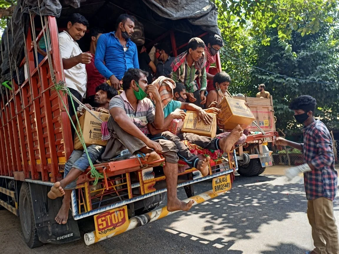 People crowding into trucks with relief supplies trying to reach home