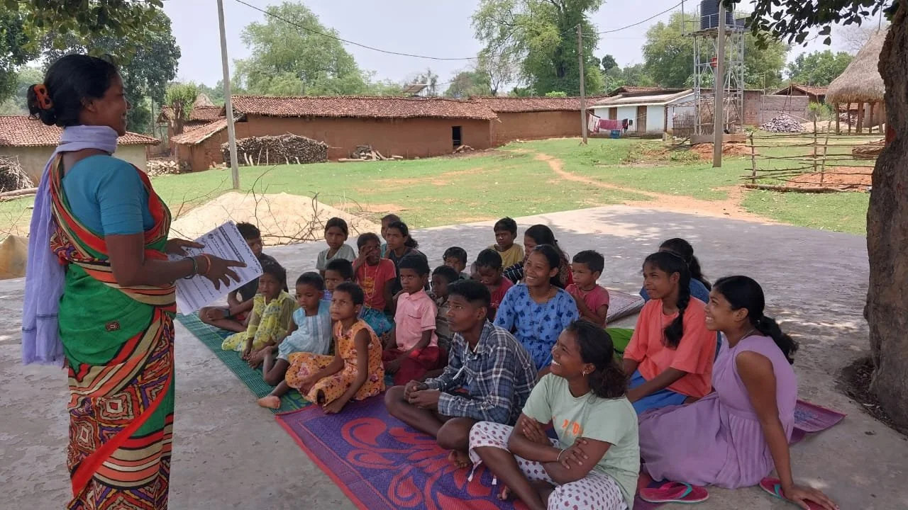 A communilty mobilizer facilitating a childrens club meeting (1).jpeg
