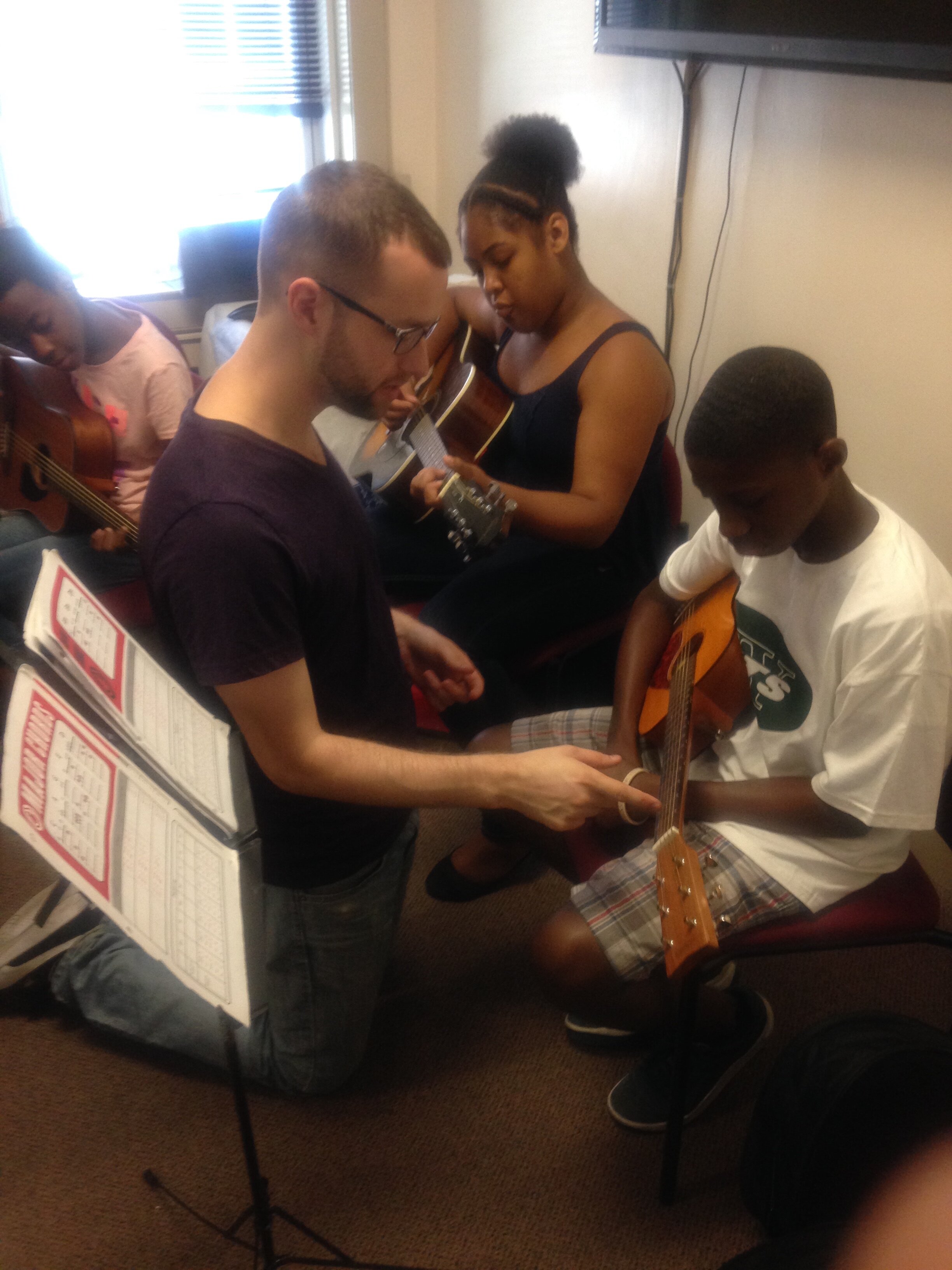 Instructor Clinton teaching beginner guitar