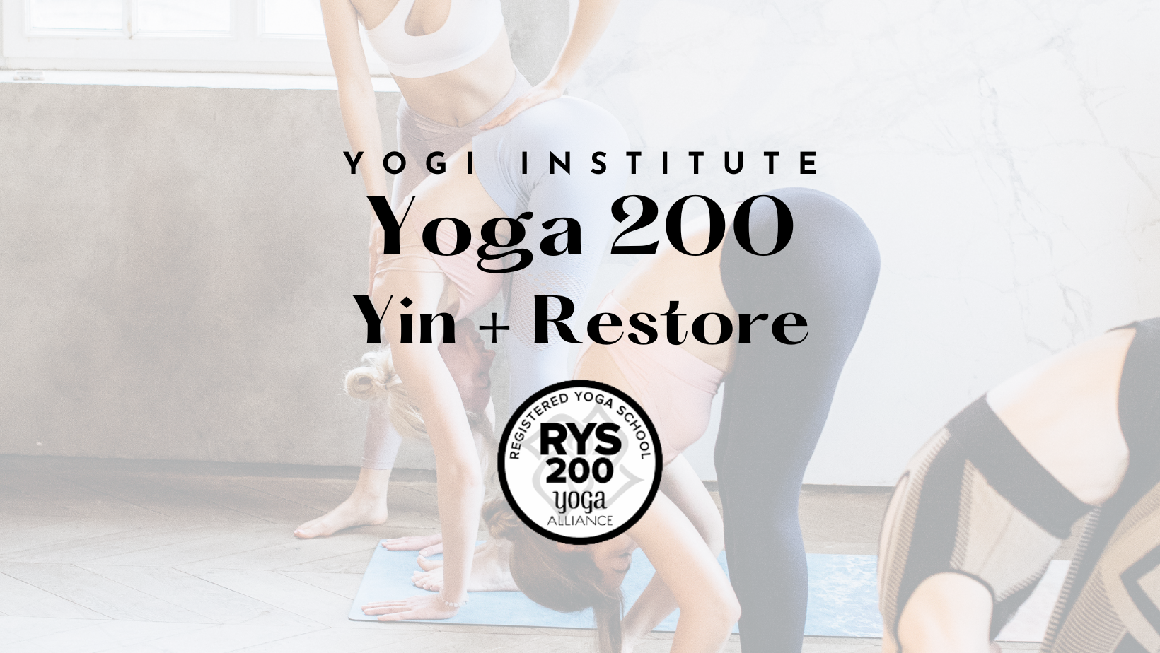 Group of women practicing yoga in a studio, with one woman in the foreground in a downward dog pose, and others in various poses in the background, all on yoga mats.