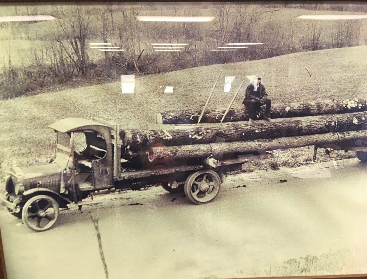  The interesting thing about this photo of Robert Gay is you see the logs and they are chained to the truck but then nothing underneath. Back then they added rear axles based on the number of the logs.   