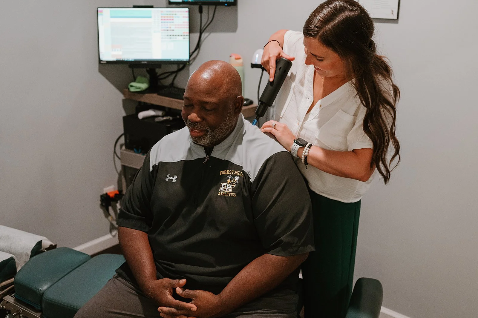 Adult receiving instrument-assisted chiropractic neck adjustment at MCH Chiropractic & Nutrition in Matthews, NC