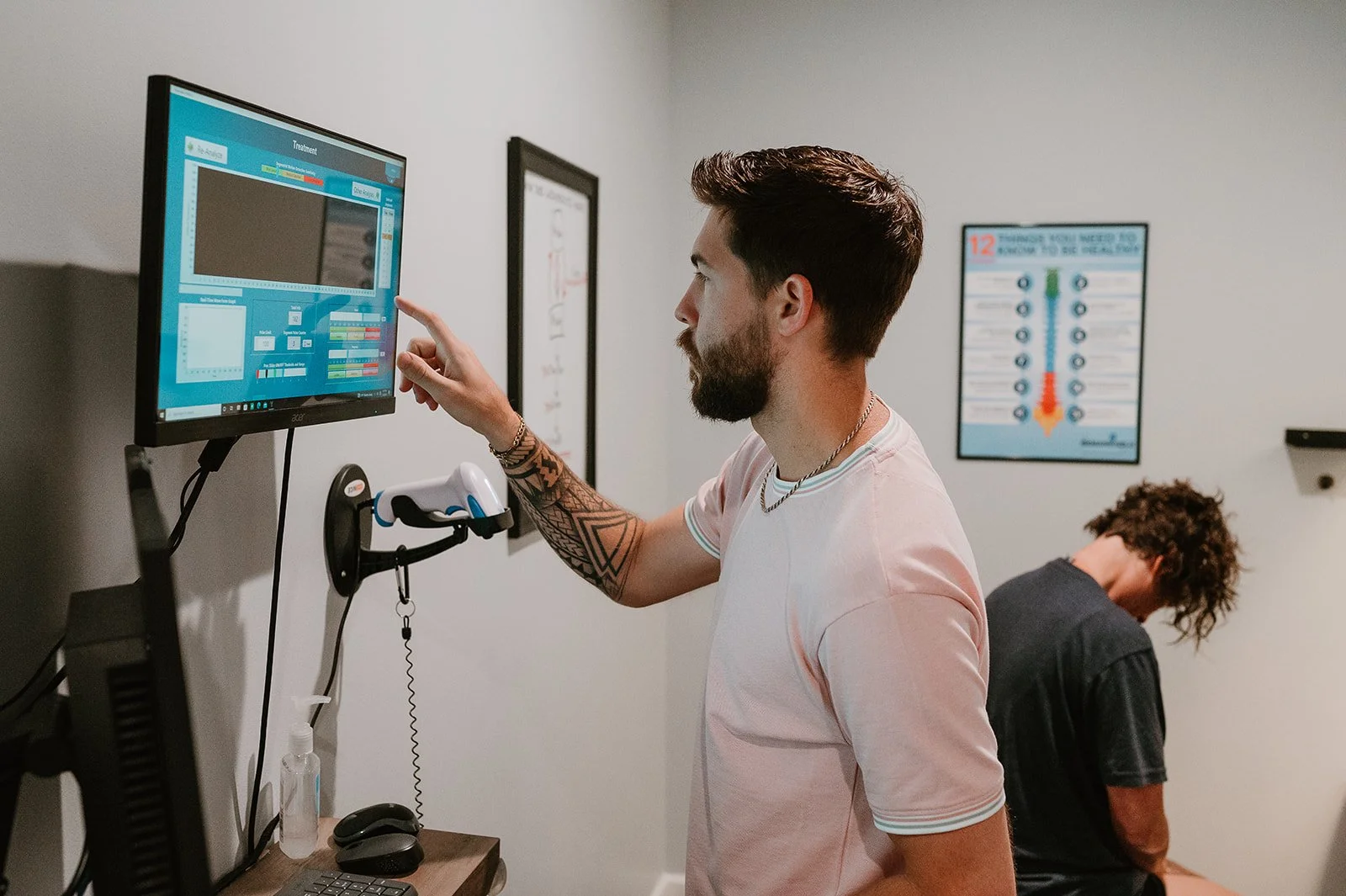 Chiropractor reviewing advanced scan data to guide personalized chiropractic care in Matthews, NC